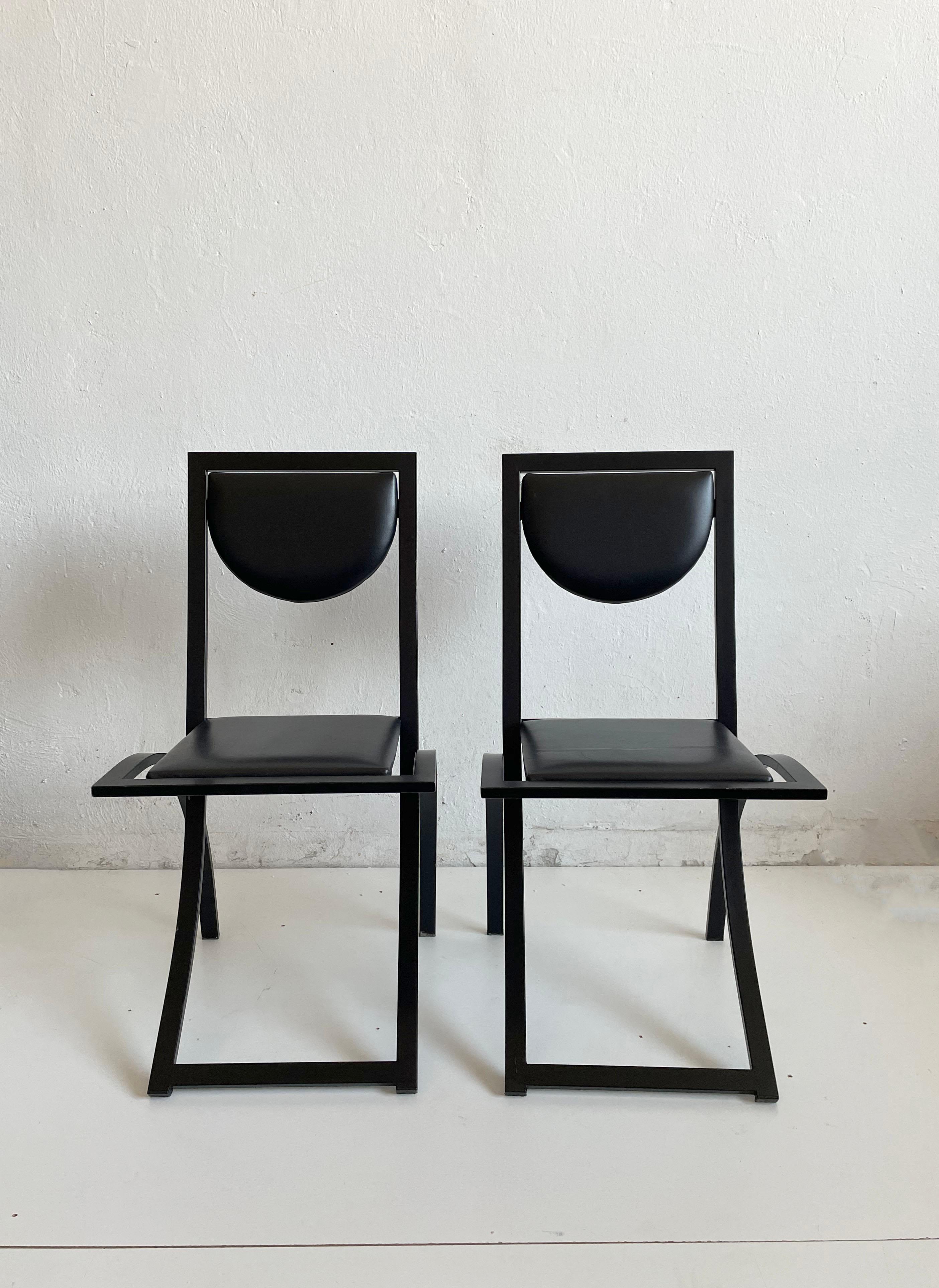 Set of 2 Postmodern dining chairs designed by Karl-Friedrich Förster, founder and owner of KFF

Age of production: ca 1990s

The chairs feature a very sturdy metal frame lacquered in matte black color and a seat and backrest upholstered in black