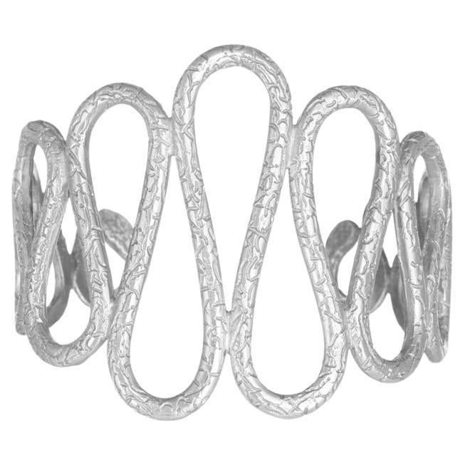Sinusoid Bangle is handcrafted from 24ct silver-plated bronze