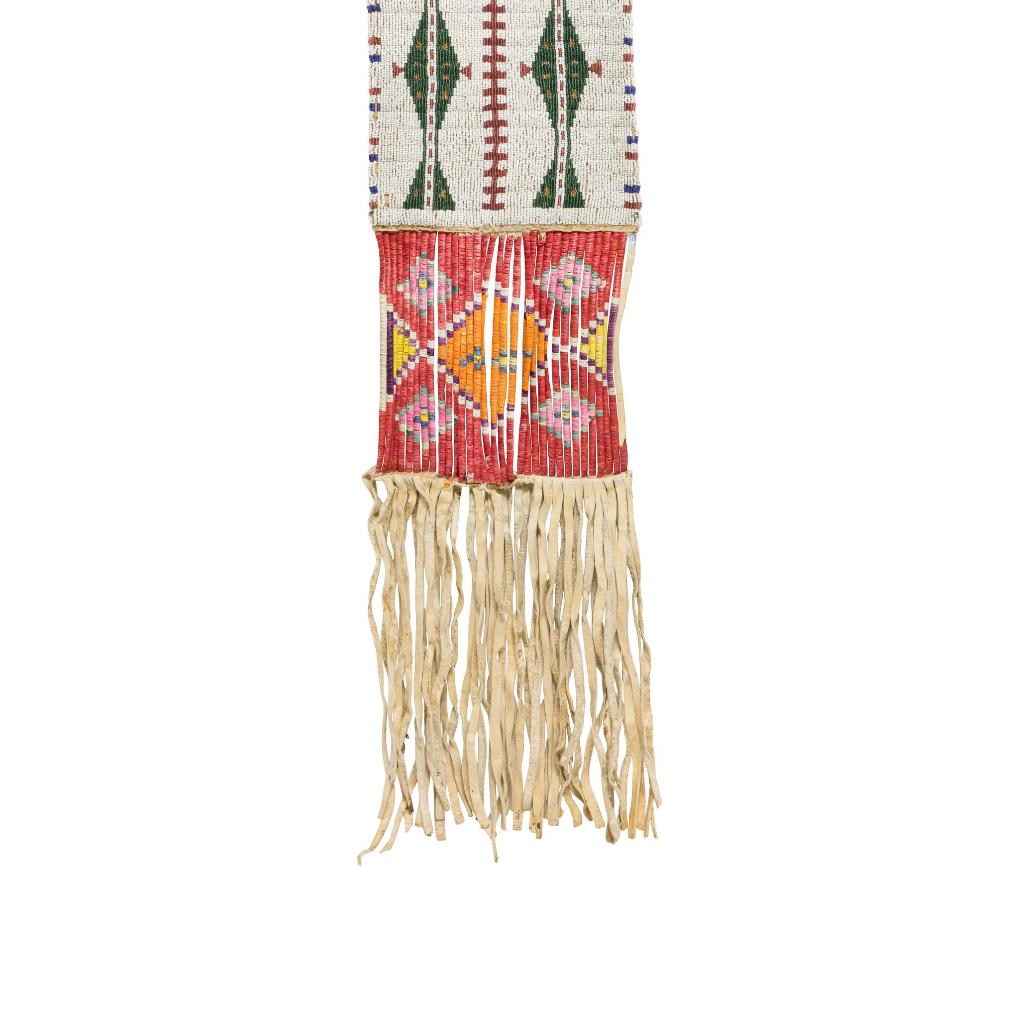 Sioux beaded pipe bag. Having large-beaded panels both sides on brain tanned buffalo. Bead patterns feature white background with green and blue traditional designs on front and back. Underneath beadwork are quilled slats on parfleche, dyed red with