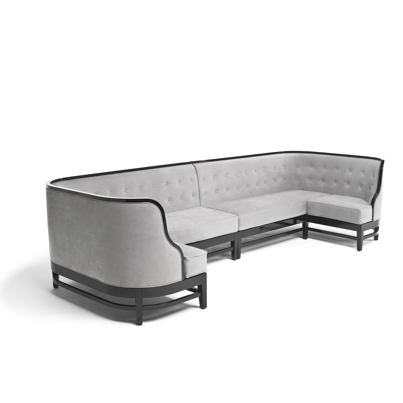 Designed to inspire intimate get-togethers, the Siparia Sofa is curved on both ends to bring you in. Crafted on a solid wood base with a glossy finish, the sofa is upholstered in soft nubuck leather, shown here in soft gray. When completed with a