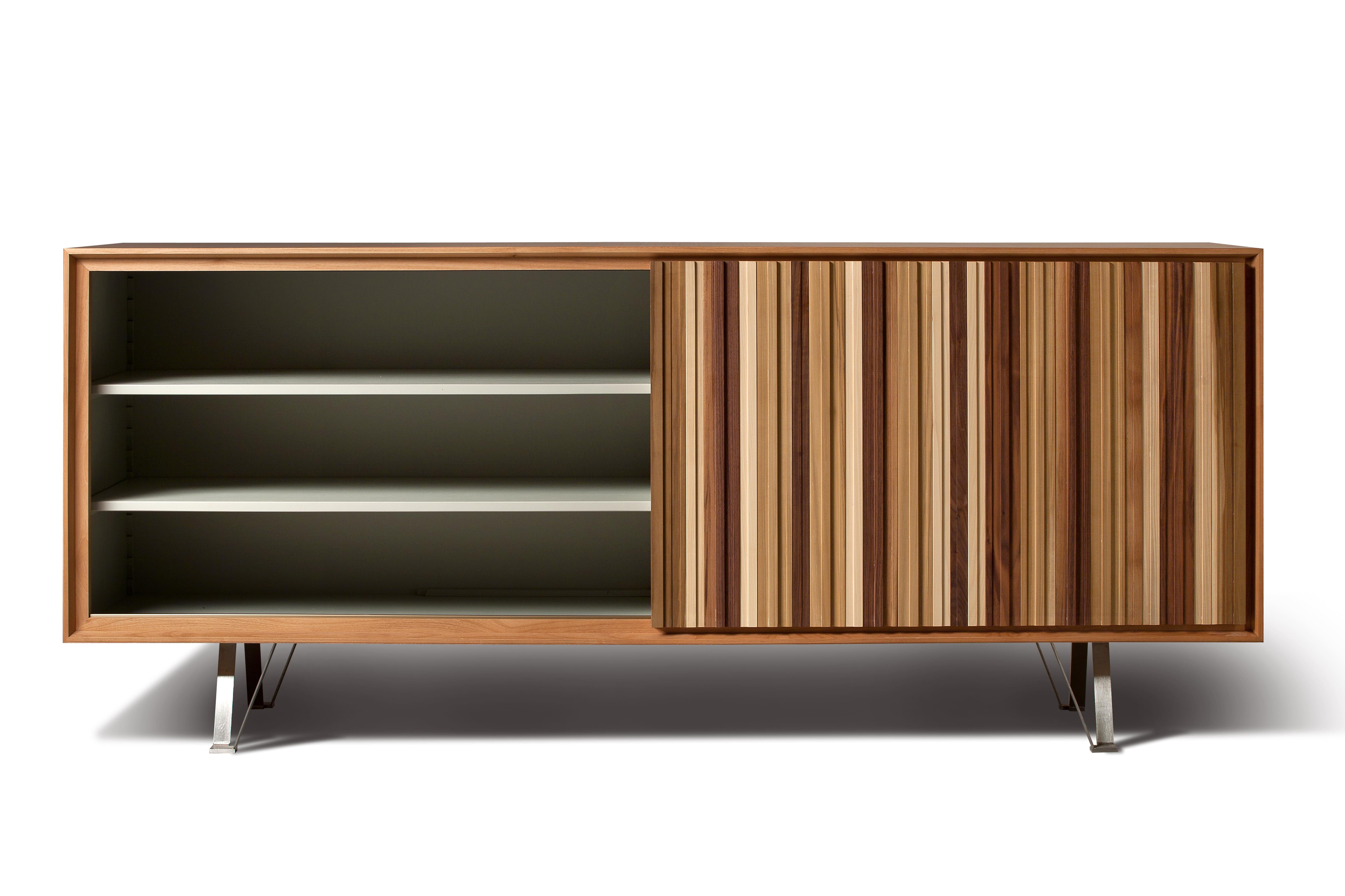 Sipario, contemporary sideboard made of cherry wood with sliding door and 3 drawers made of canaletto walnut wood.
Customizable in different wood finishes
Made in Italy by Morelato
   