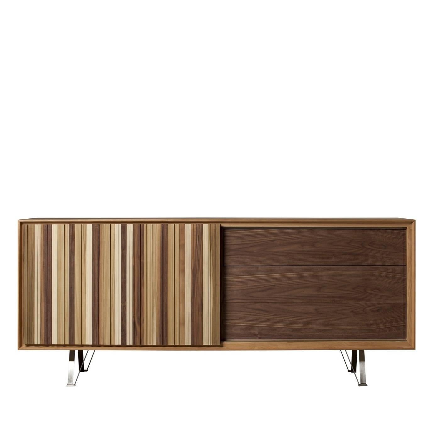 This striking sideboard features a sliding door whose front panel is made by vertically assembled parallel listels of different types of wood that, with their different textures and colors, create a unique effect and add a vertical element to the