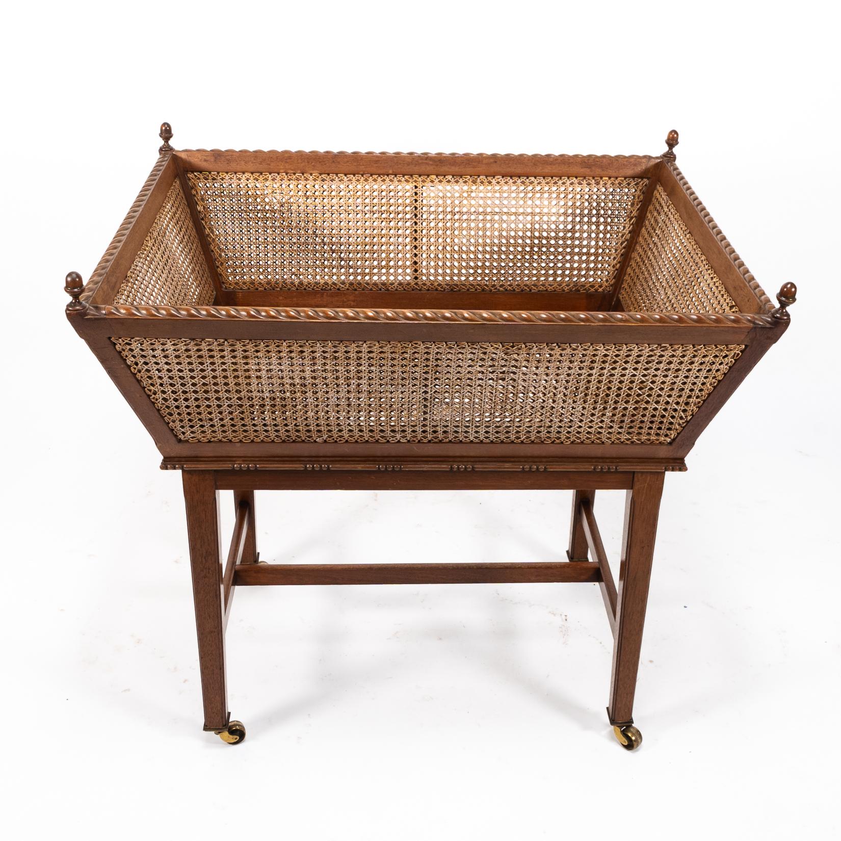 Sir Edwin Landseer Lutyens
A rare newspaper basket with Acorn finials (replaced), and a gadrooned top edge, of tapering form with ball moldings around the base of the basket. Standing on square molded tapering legs united by a H stretcher, and