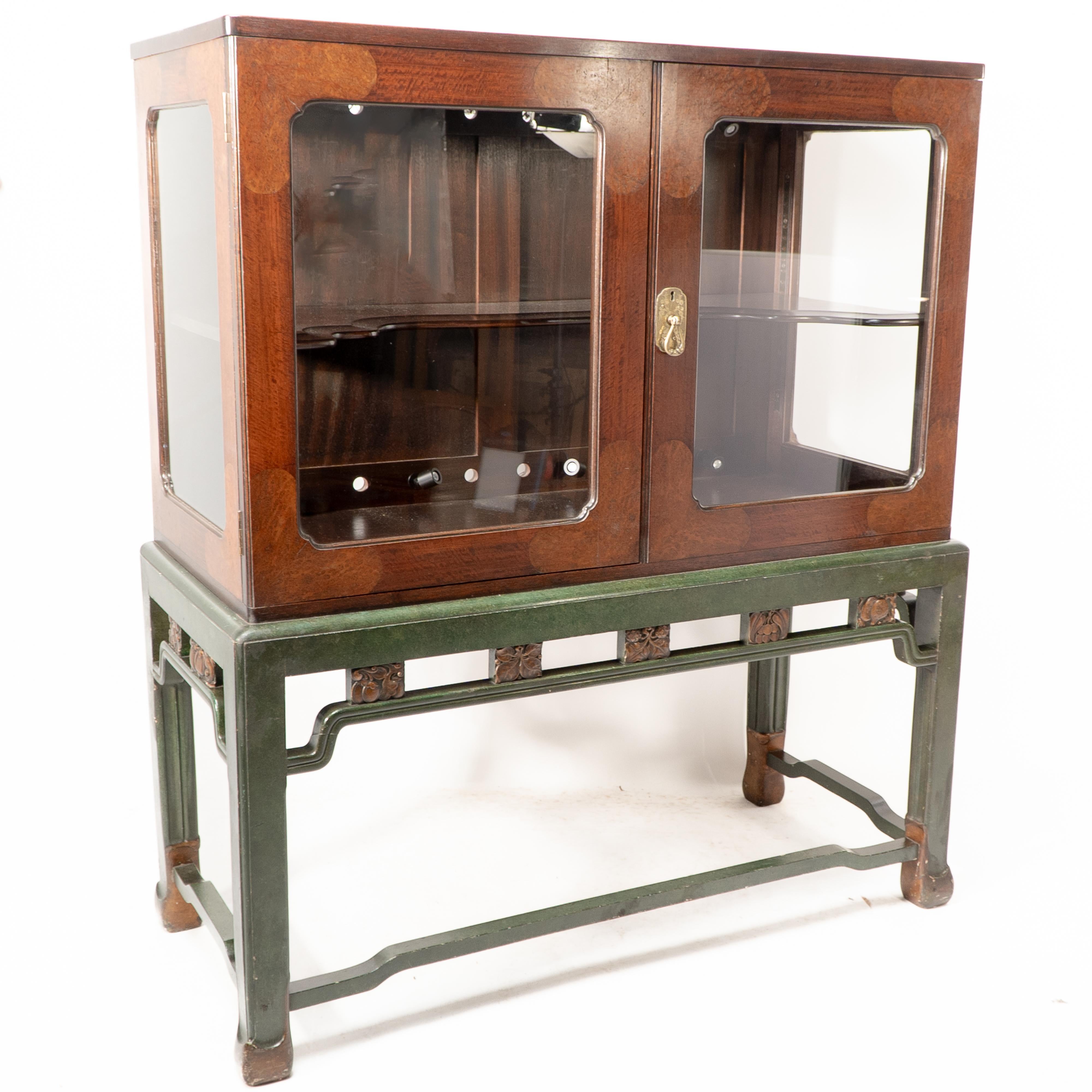 Sir Robert Lorimer attributed, for Whytock and Reid Edinburgh. An Anglo-Chinese mahogany and burr walnut display cabinet with green painted and gilded wood.Literature: Savage, Peter, 'Lorimer and the Edinburgh Craft Designers', Steve Savage 1980, p.