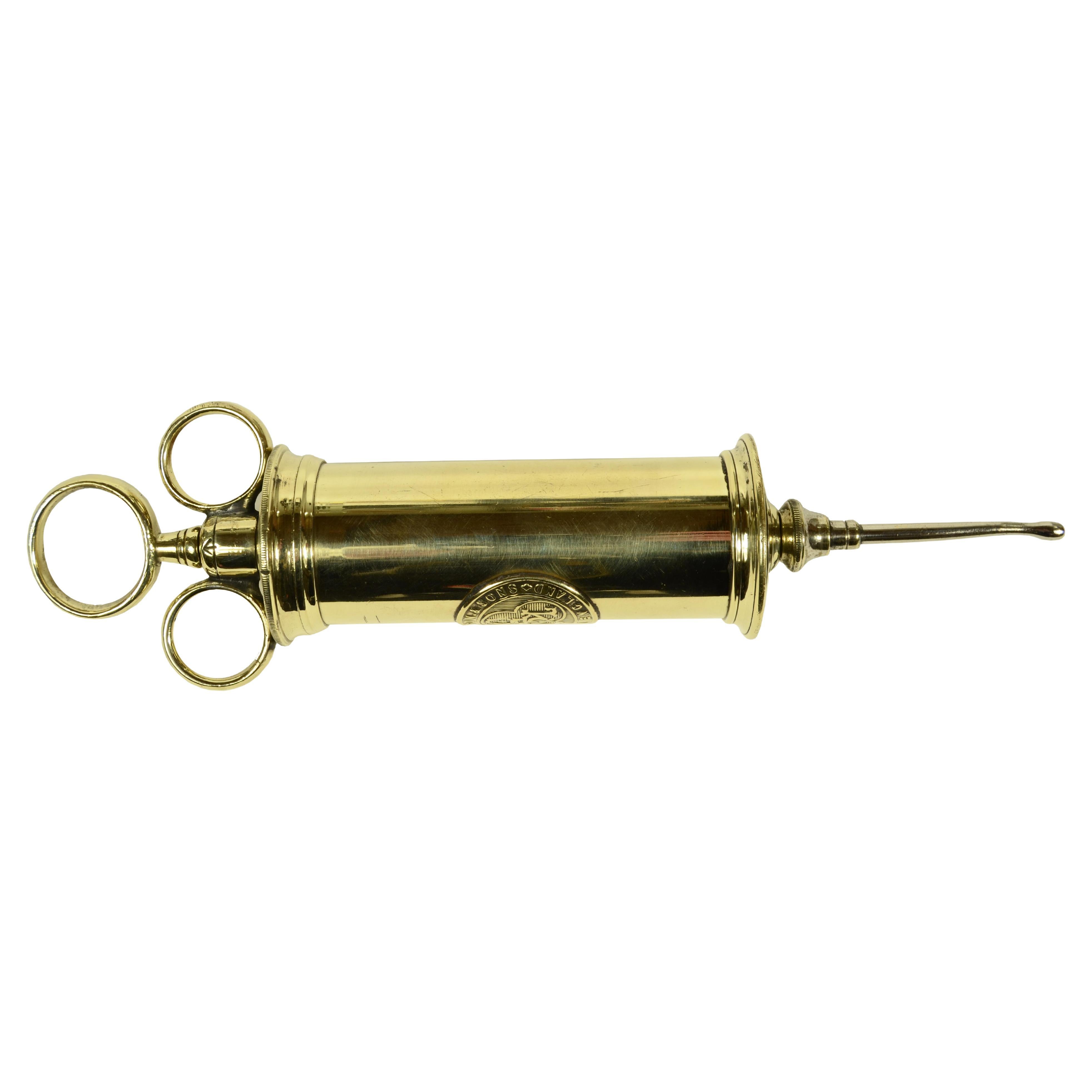 Brass syringe signed S. Maw Son & Sons London from the late 19th century