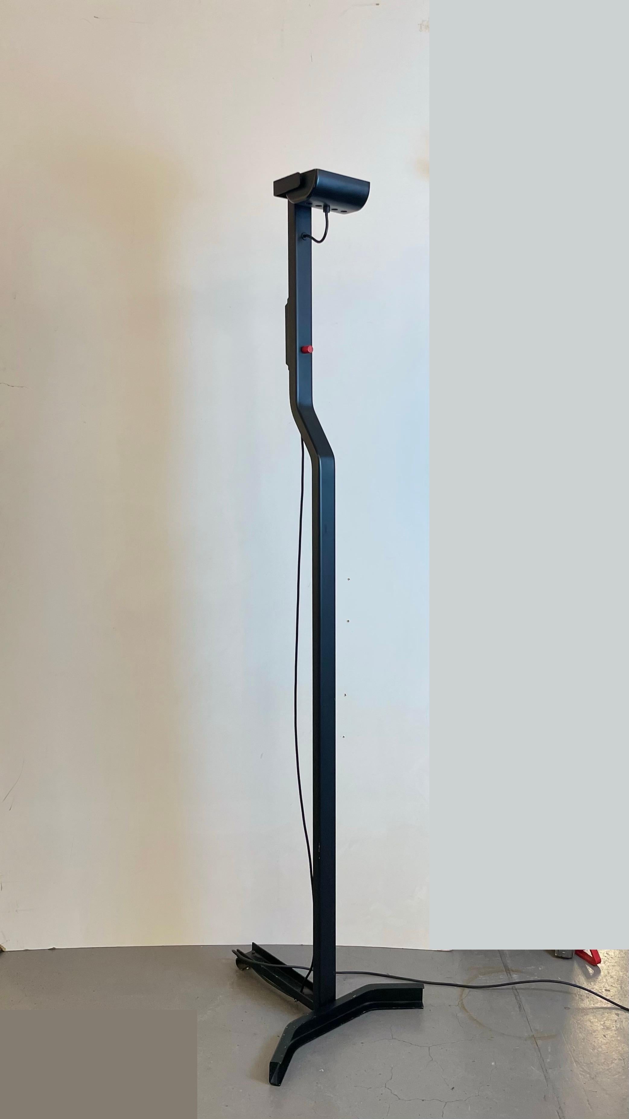 Minimalist Post-Modern floor lamp named Sirio T. Made of black powdered metal with a touch of red (switch), this lamp is dimmable and adjustable. Drawn by Japanese designer Kazuhide Takahama for the Italian innovative brand Sirrah in the