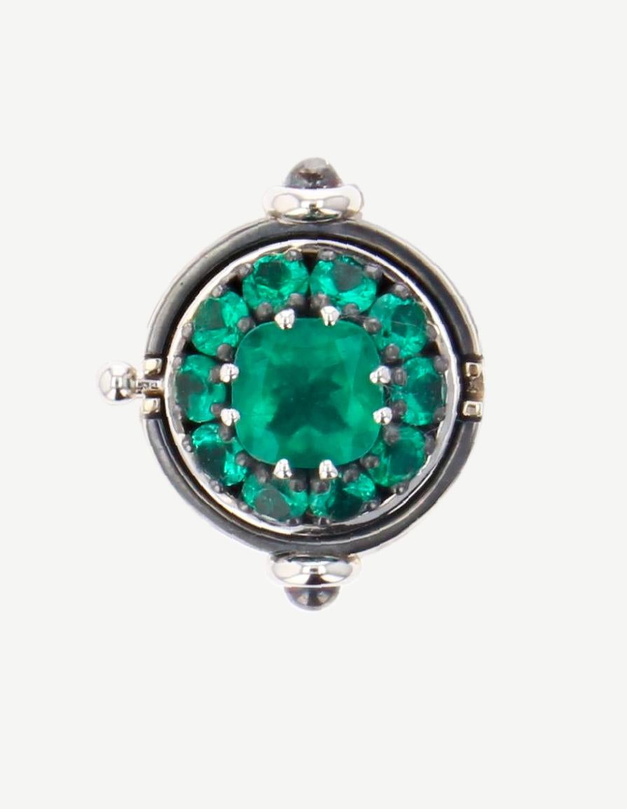 Emerald Diamonds Sphere Medium Ring in 18 white gold by Elie Top. This statement ring is made of a mobile 18K white gold half-sphere, mounted on a patinated silver rail, opens up to reveal a cushion-cut emerald surrounded by 10 emeralds.