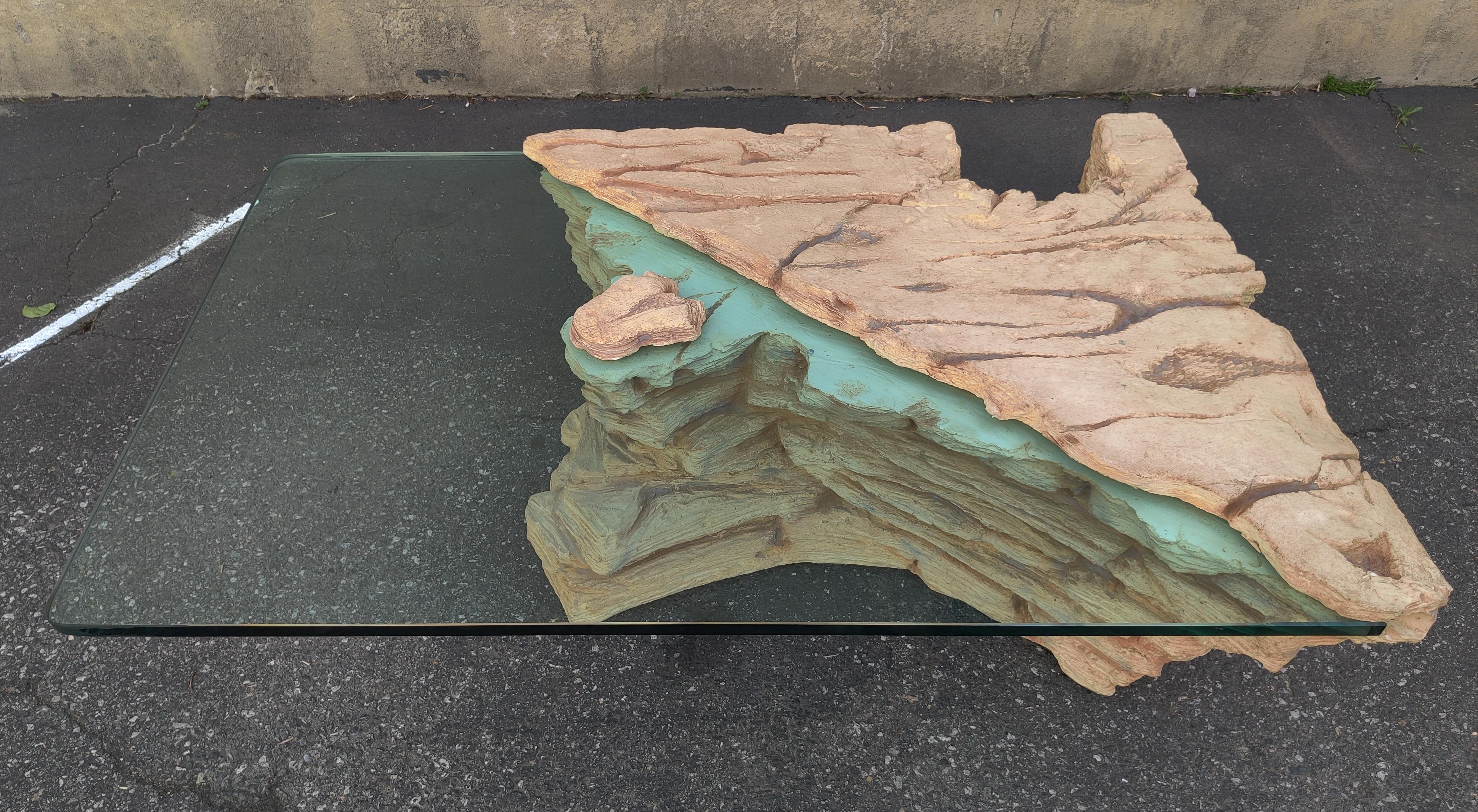 Sirmos attribution 'Rock Quarry' coffee table. Made in the US circa 1970s. 3/4 inch thick glass top fits invisibly in a groove in the body of the base and is held down with a rock that makes it seem like the base is coming through the glass top.