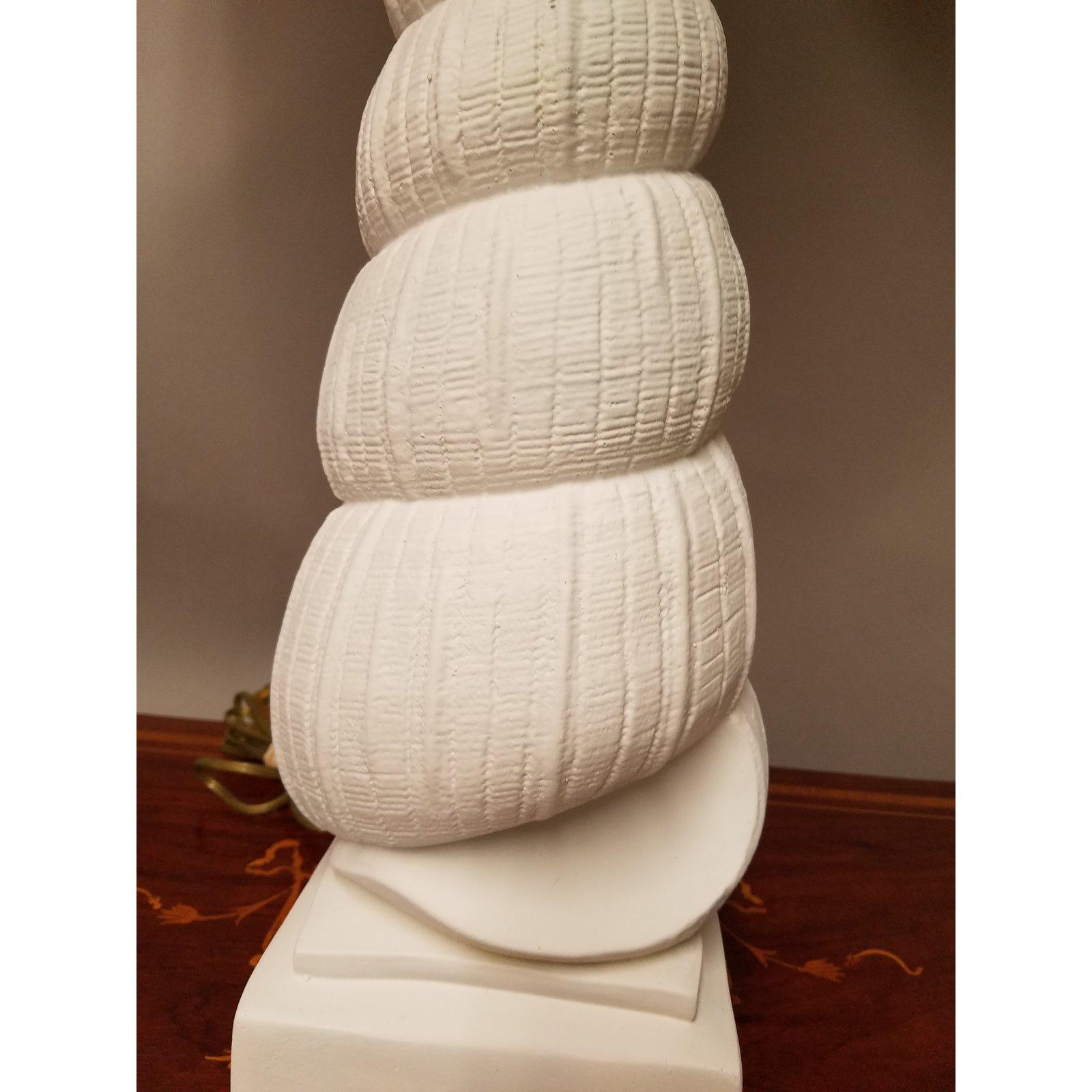 Great looking cast plaster shell lamp with a flat white painted finish. Chic style for a coastal home. The shade is for photographic purposes only and not included with the lamp. 34 inches tall to the top of a shade.
 
