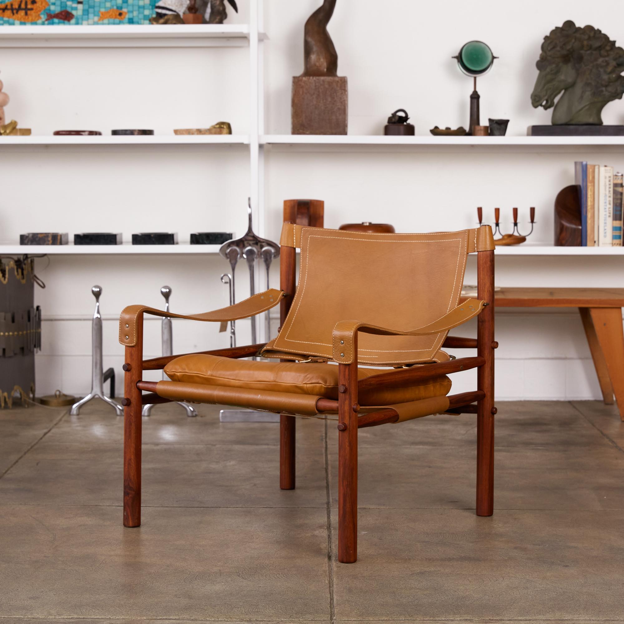 A 'Sirocco' safari chair designed by Arne Norell in 1966 and produced by Scanform in Colombia, a company licensed to manufacture the Sirocco chair for export to the US. This example features a solid rosewood frame strapped together by