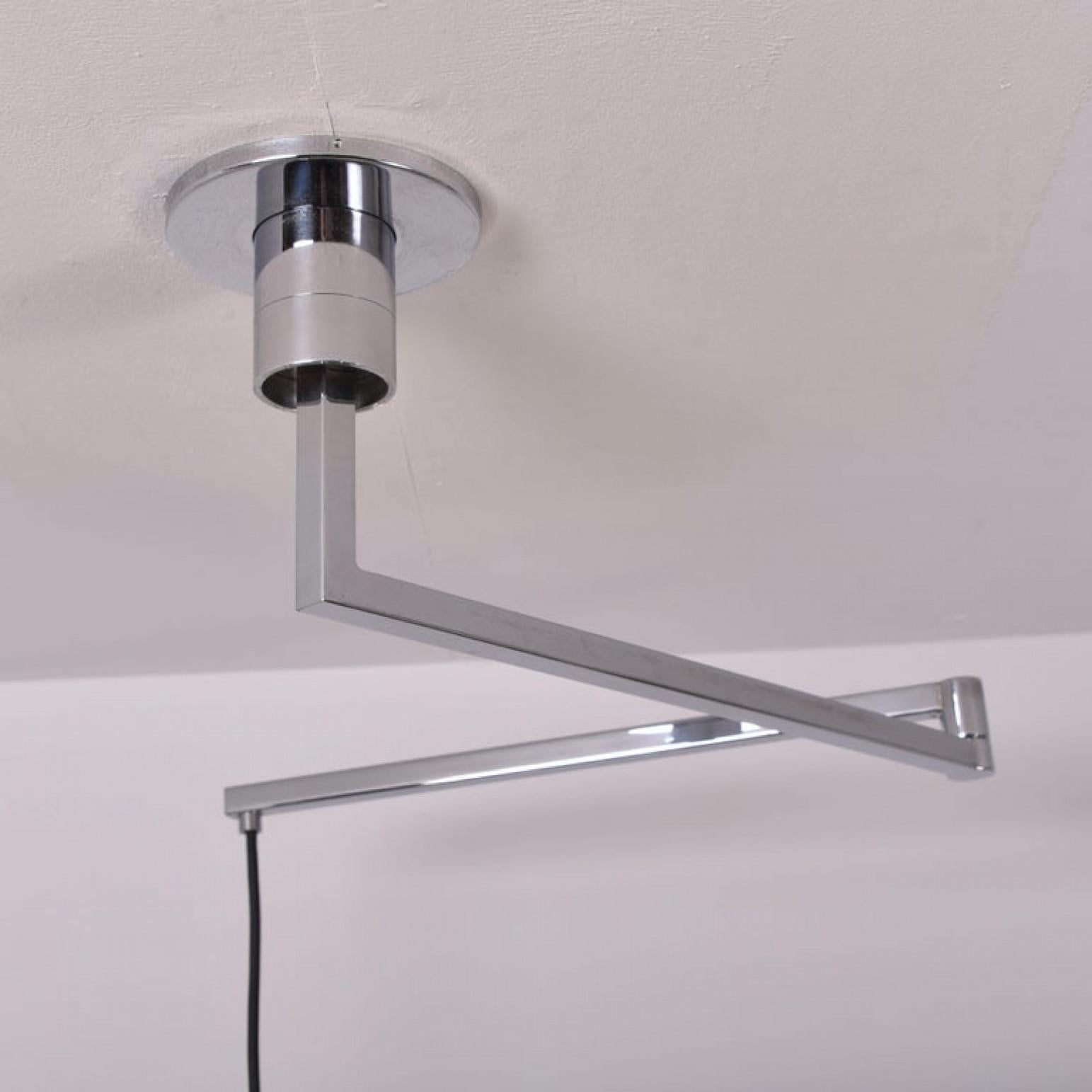 Chrome-plated ceiling lamp from 1969 with two-piece metal arm, which can sprawl and rotate around the mounting. The bell is lacquered white inside. This lamp is one of Franco Albini's AM/AS lighting series for Sirrah in Italy. A high end beauty of