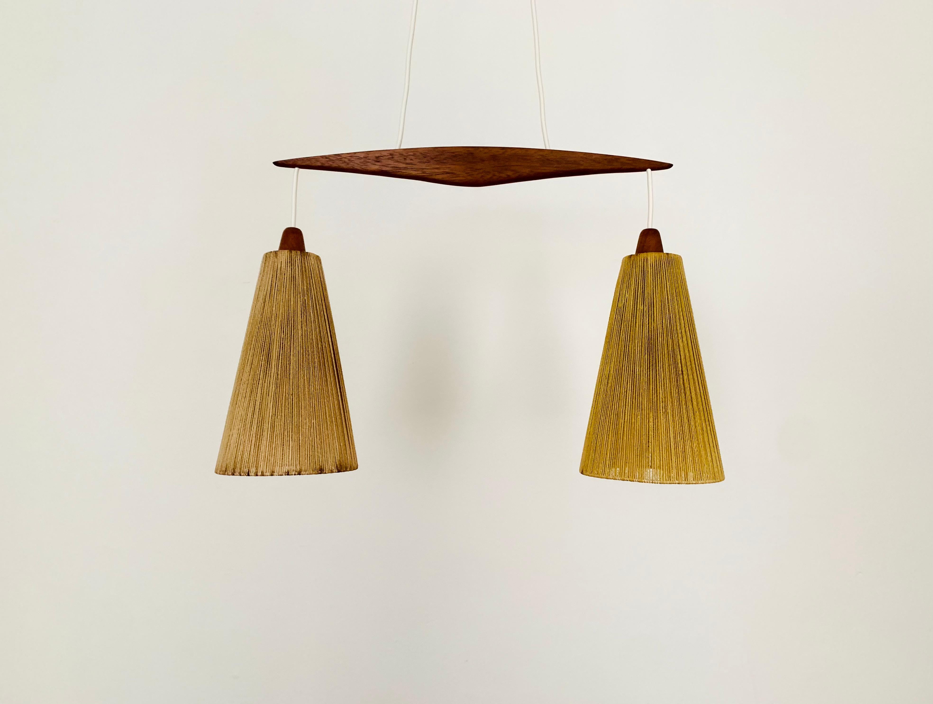Beautiful sisal pendant lamp from the 1960s.
Great and unusual design with a fantastically comfortable look.
Very nice teak details and high-quality workmanship.
A spectacular play of light is created.

Manufacturer: Temde

Condition:

Very good
