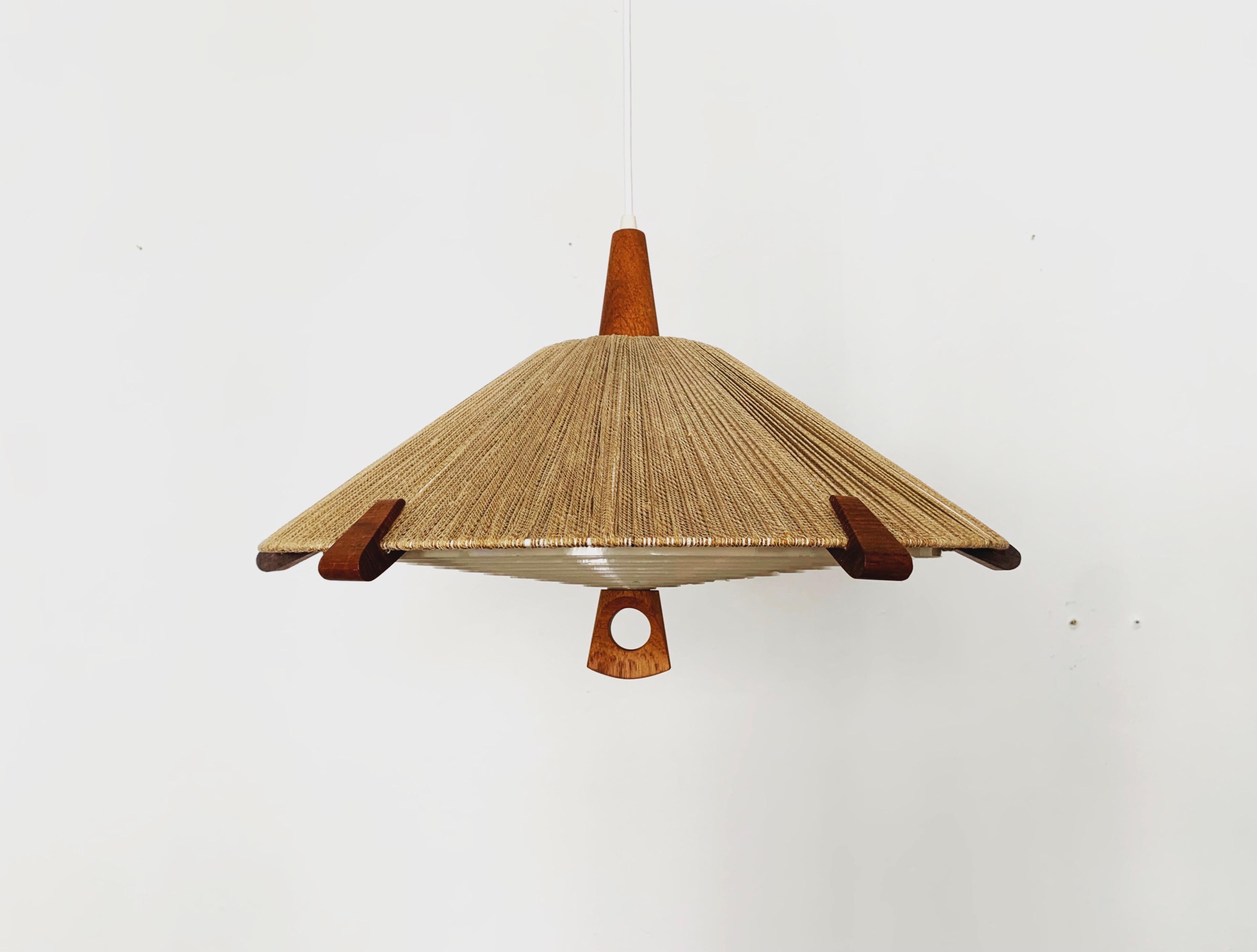 Exceptionally beautiful and very rare pendant light from the 1960s.
The design is very unusual.
The shape and the materials create a warm and very pleasant light.
Particularly beautiful teak details.

Manufacturer: Temde

Condition:

Very good