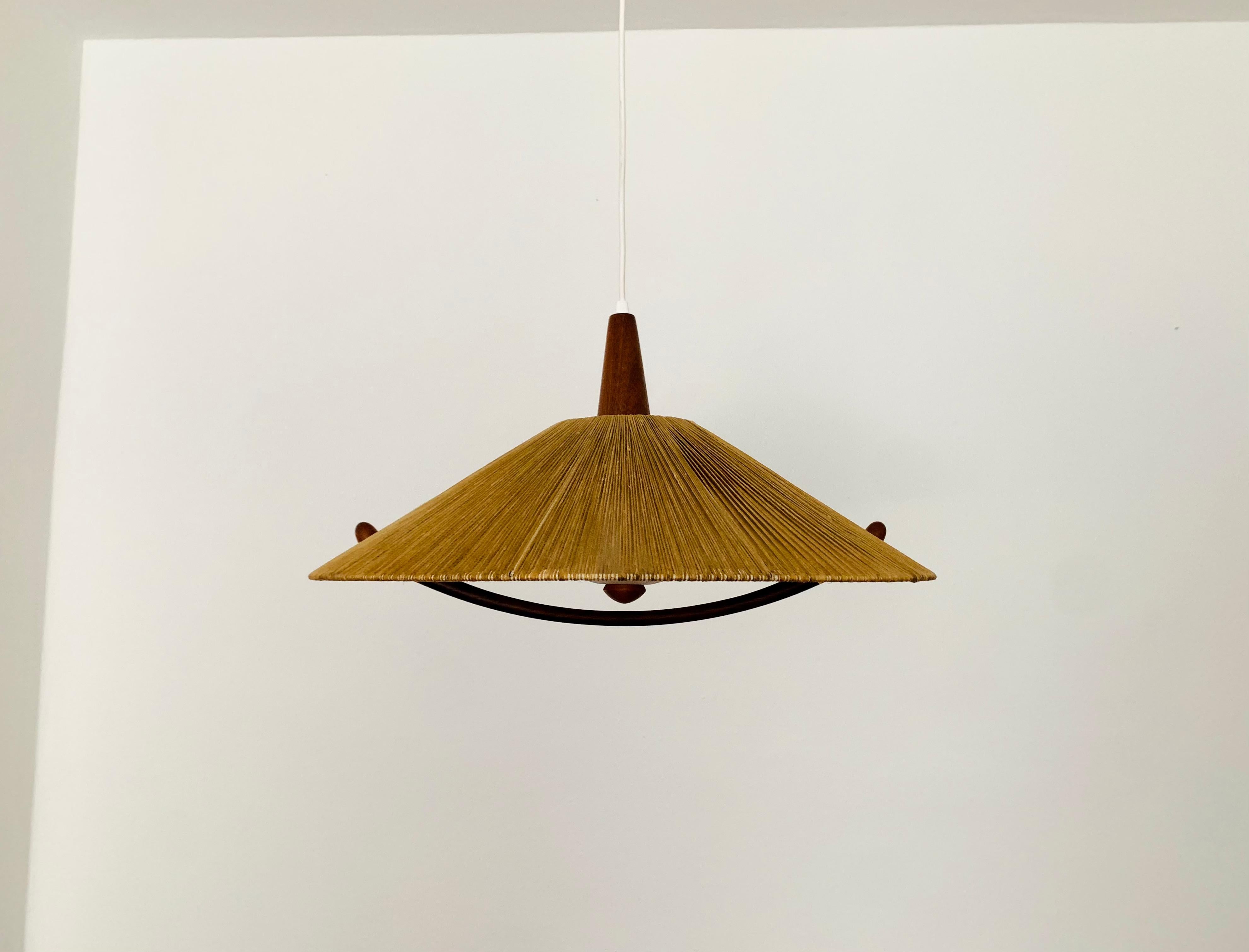 Exceptionally beautiful and large pendant lamp from the 1960s.
The design is very unusual.
The shape and the materials create a warm and very pleasant light.
The teak details are beautifully shaped.

Condition:

Very good vintage condition with