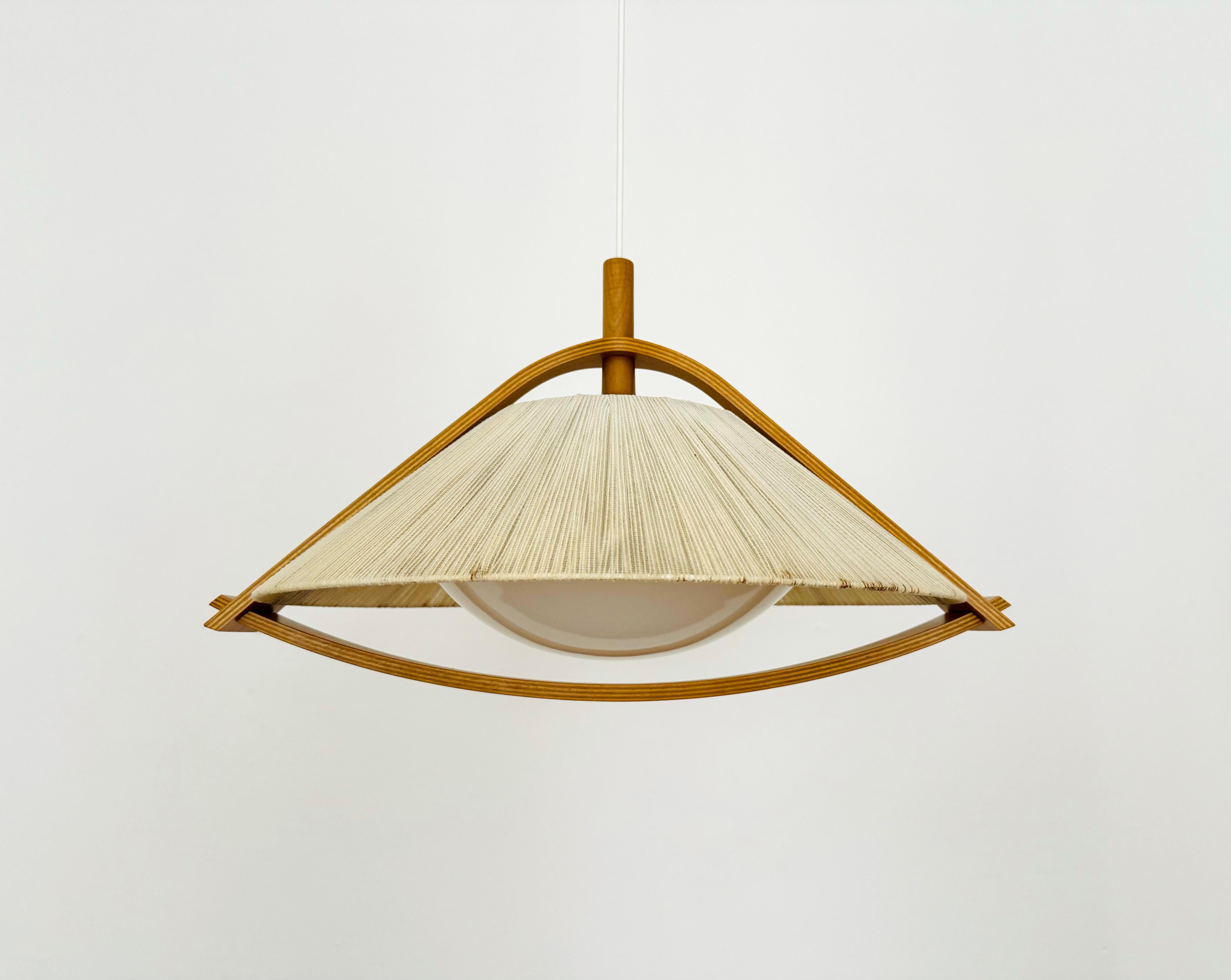 Exceptionally beautiful and large pendant lamp from the 1960s.
The design is very unusual.
The shape and materials create a warm and very pleasant light.

Condition:

Very good vintage condition with slight signs of age-related wear.
The raffia