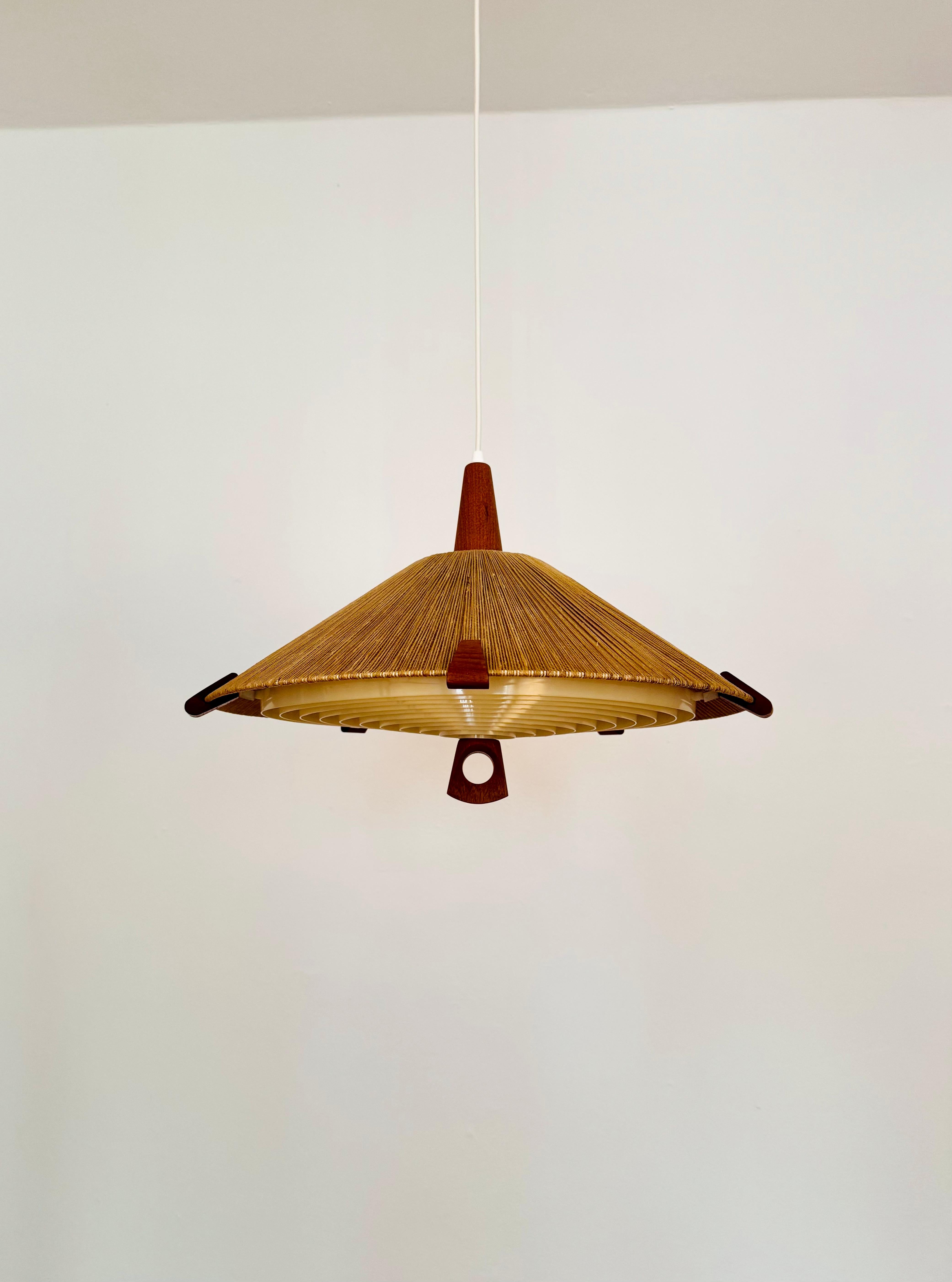 Lampada a sospensione eccezionalmente bella e molto rara degli anni '60.
Il design è molto insolito.
La forma e i materiali creano una luce calda e molto piacevole.
Particolarmente belli i dettagli in teak.

Produttore: