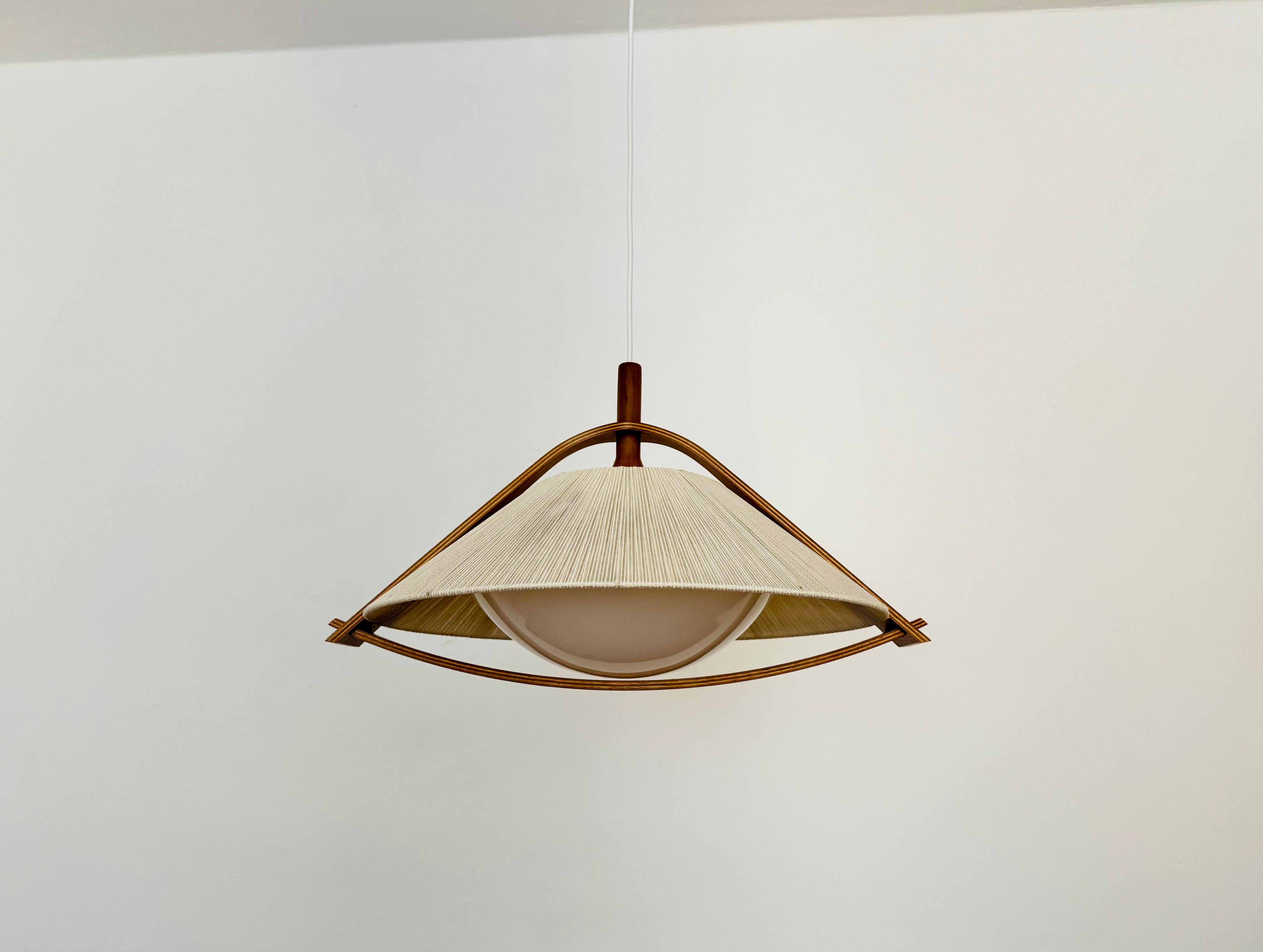 Exceptionally beautiful and large pendant lamp from the 1960s.
The design is very unusual.
The shape and materials create a warm and very pleasant light.

Condition:

Very good vintage condition with slight signs of age-related wear.
The raffia