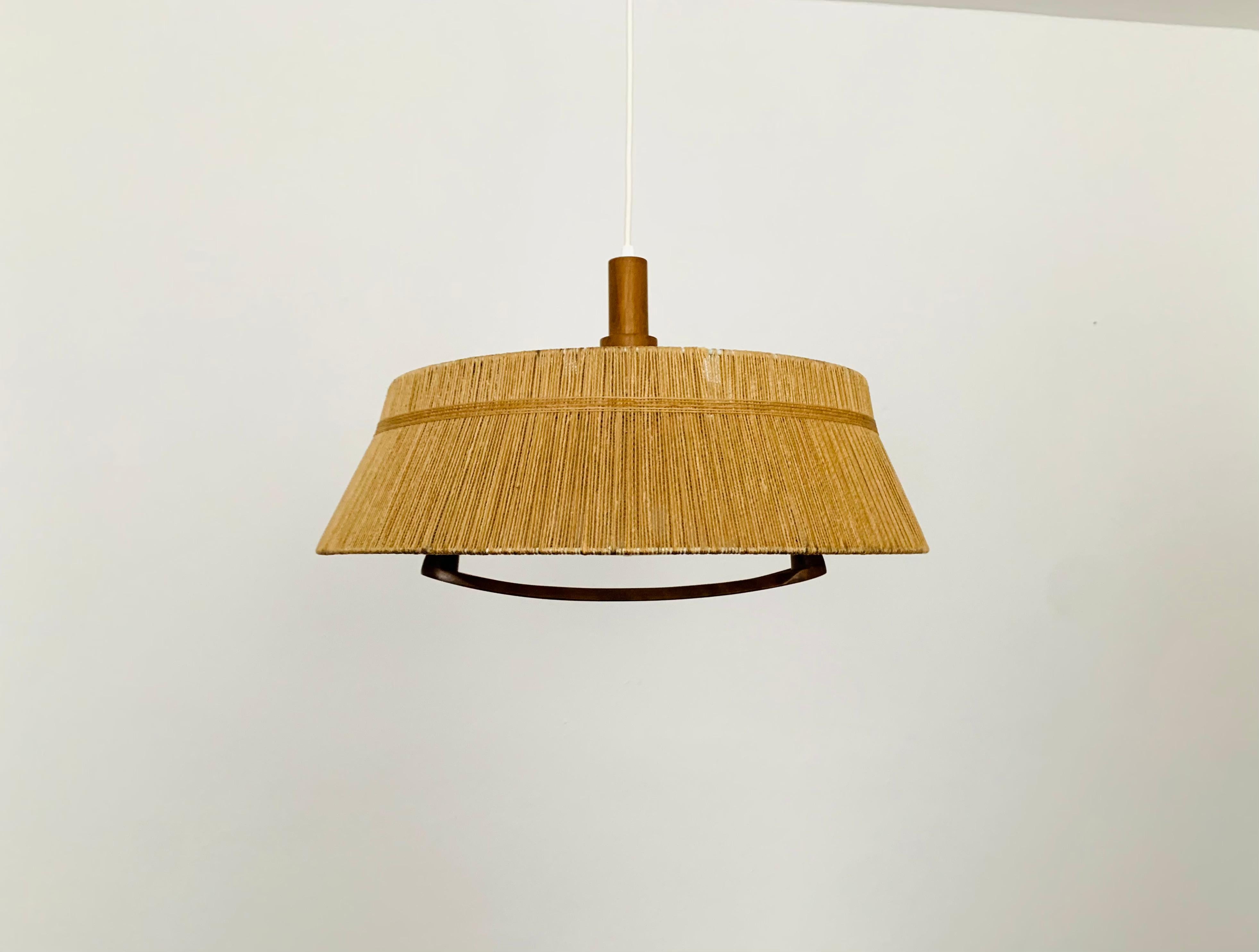 Exceptionally beautiful and large pendant lamp from the 1960s.
The design is very unusual.
The shape and the materials create a warm and very pleasant light.

Manufacturer: Temde

Condition:

Very good vintage condition with slight signs of wear
