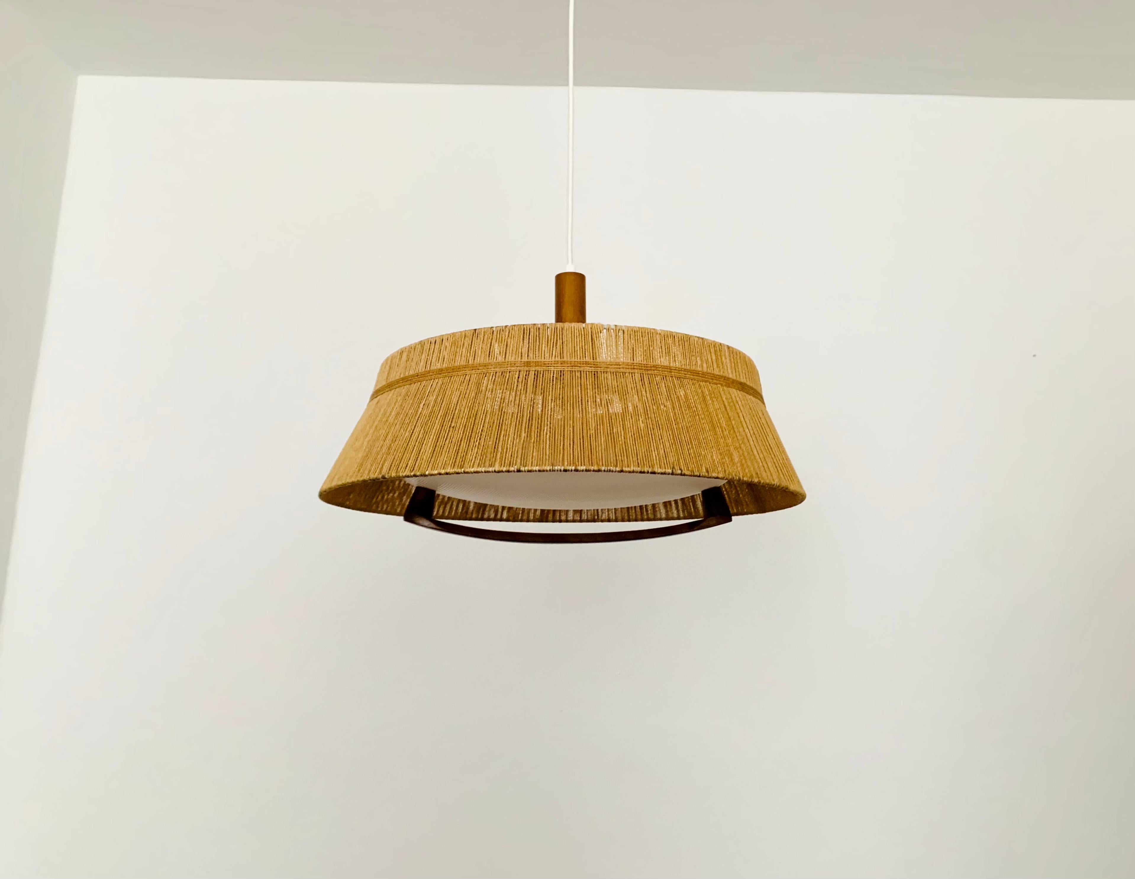 Exceptionally beautiful and large pendant lamp from the 1960s.
The design is very unusual.
The shape and materials create a warm and very pleasant light.

Manufacturer: Temde

Condition:

Very good vintage condition with slight signs of age-related