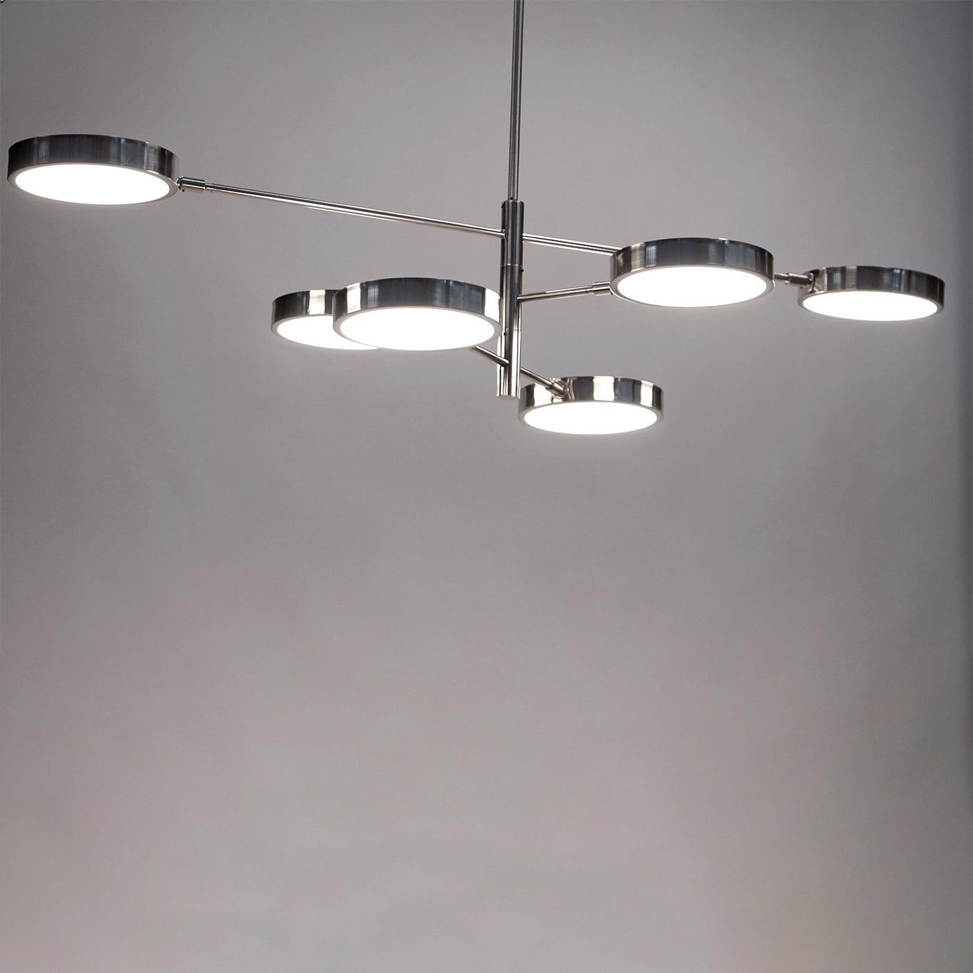 The Brass Sistema chandelier features a nickel-plated, lightly brushed finish. The ingenious rotating stem structure and staggered arms provide flexibility, making it perfect for regular or low-ceiling rooms. This medium-sized chandelier has 3 arms
