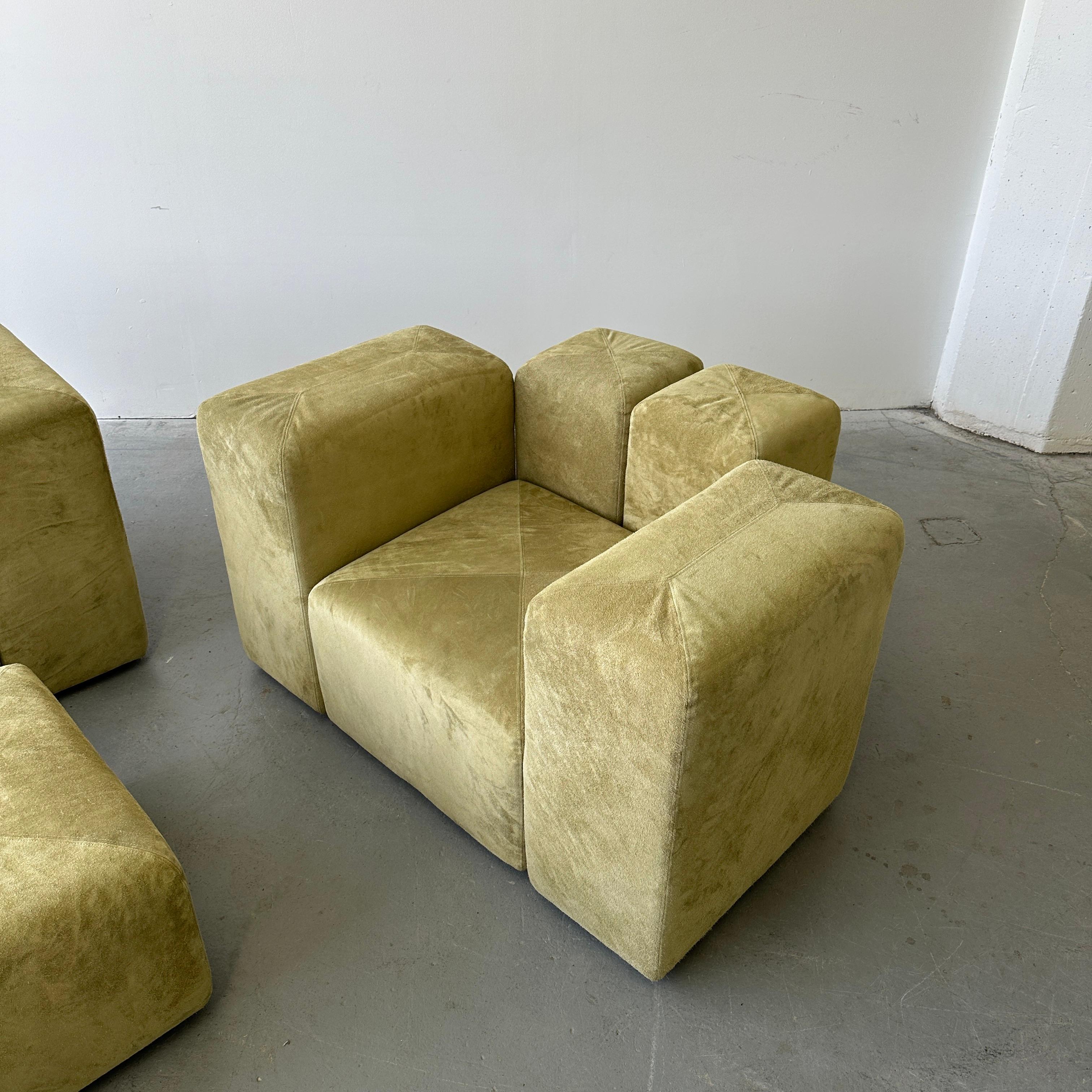 Signed c. 1970s and fully reupholstered in Holly Hunt Suede. This set is fully modular. Each piece can be removed and rearranged. Metal connectors that reach deep under the chair give full stability and ensure that each arrangement sits comfortably.