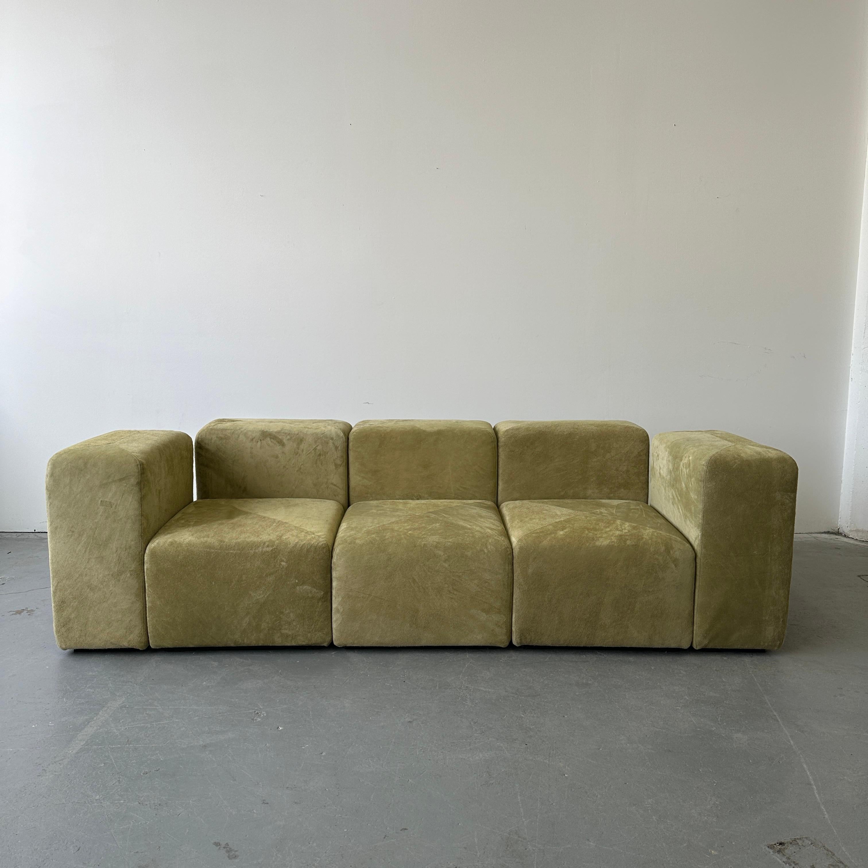 Signed c. 1970s and fully reupholstered in Holly Hunt Suede. This set is fully modular. Each piece can be removed and rearranged. Metal connectors that reach deep under the sofa give full stability and ensure that each arrangement sits comfortably.