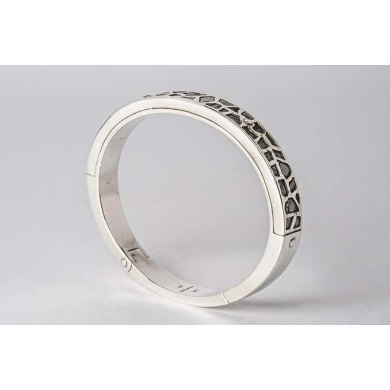 Bracelet in polished sterling silver and slabs of rough black diamond fragment set in mega pave setting. These slabs are removed from a larger chunk of diamond. This item is made with a naturally occurring element and will vary from the photograph