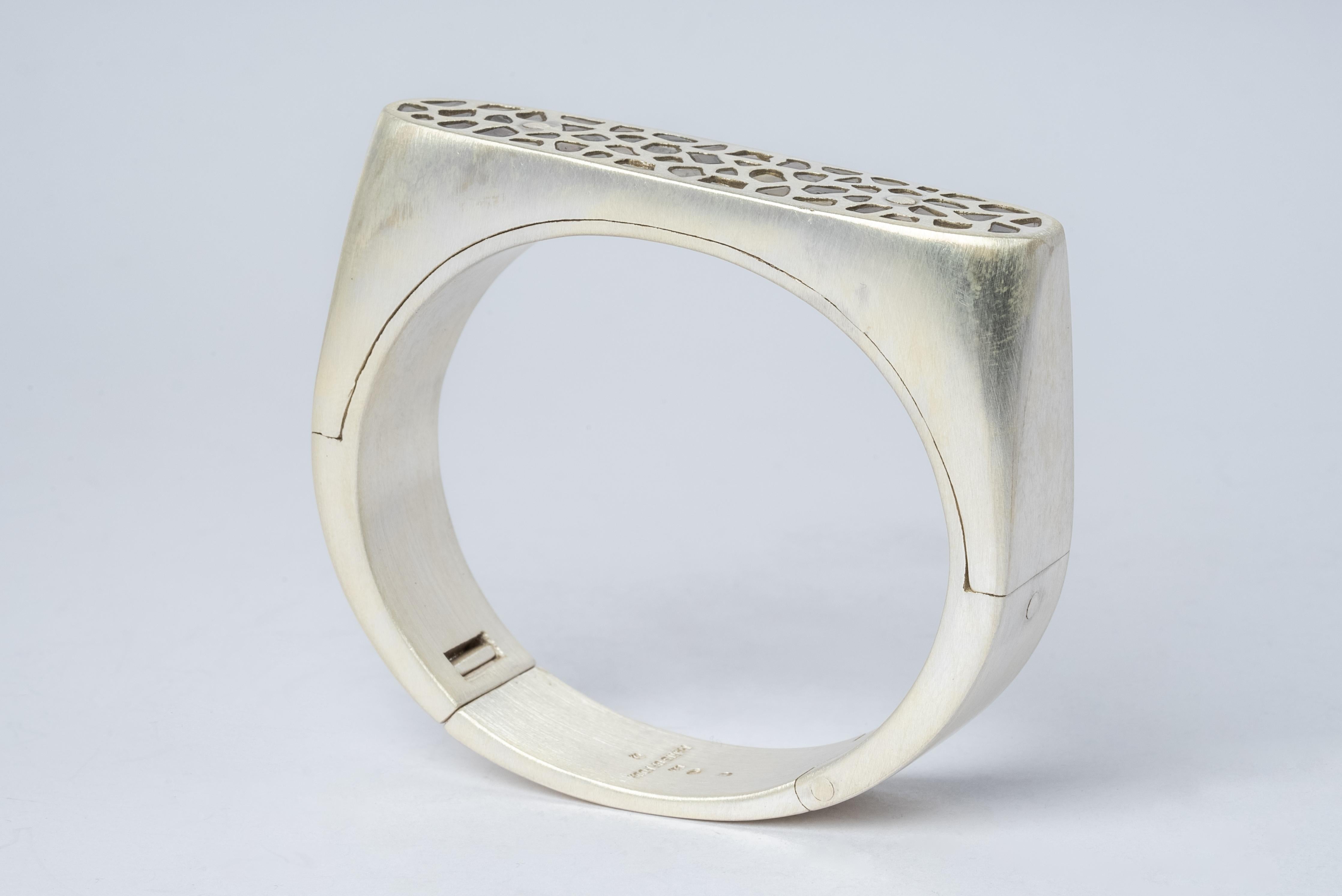 Bracelet in sterling silver and slabs of rough diamond set in mega pave setting. These slabs are removed from a larger chunk of diamond. This item is made with a naturally occurring element and will vary from the photograph you see. Each piece is