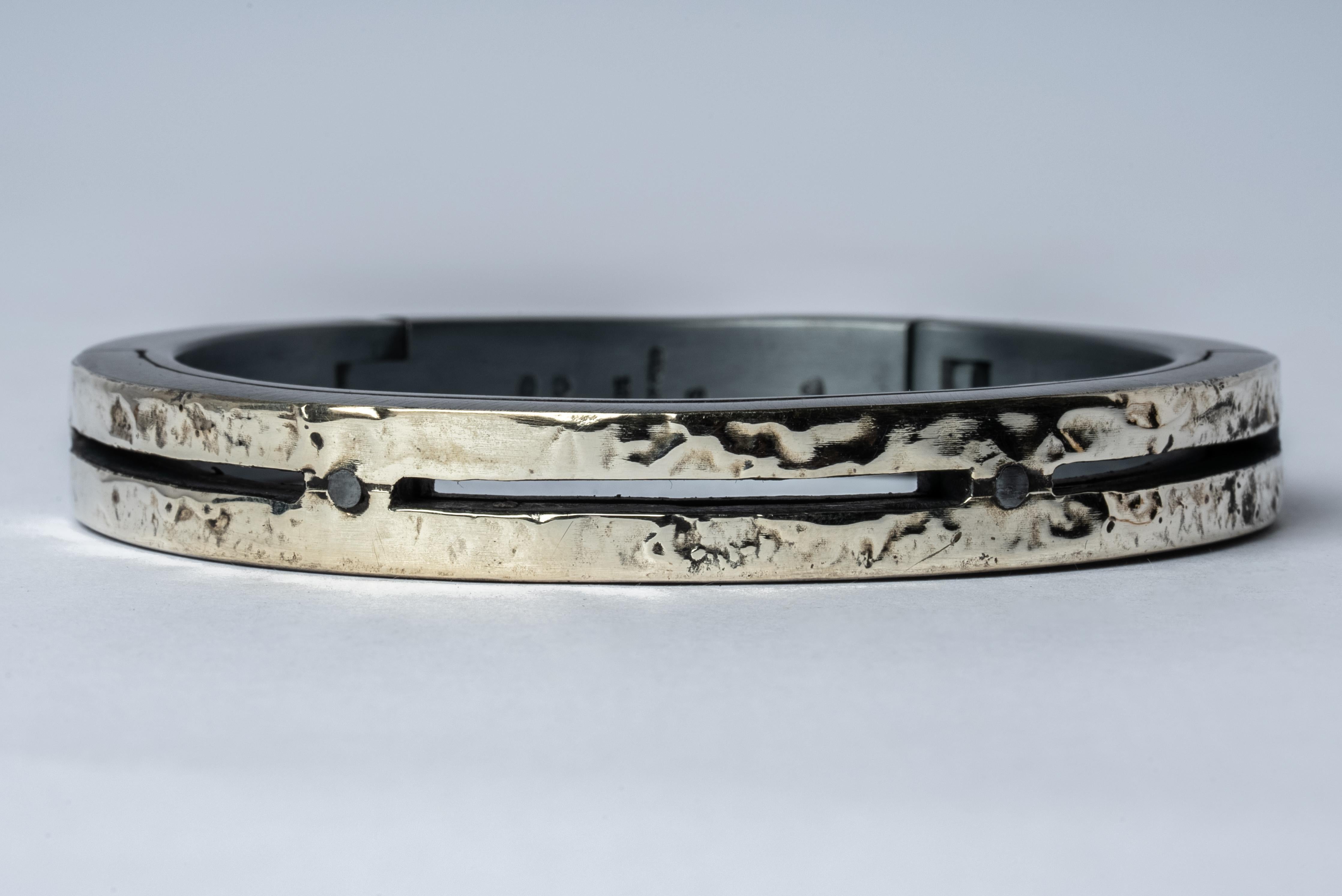 Sistema bracelet in sterling silver and 10k solid white gold layer fused on the surface. The 