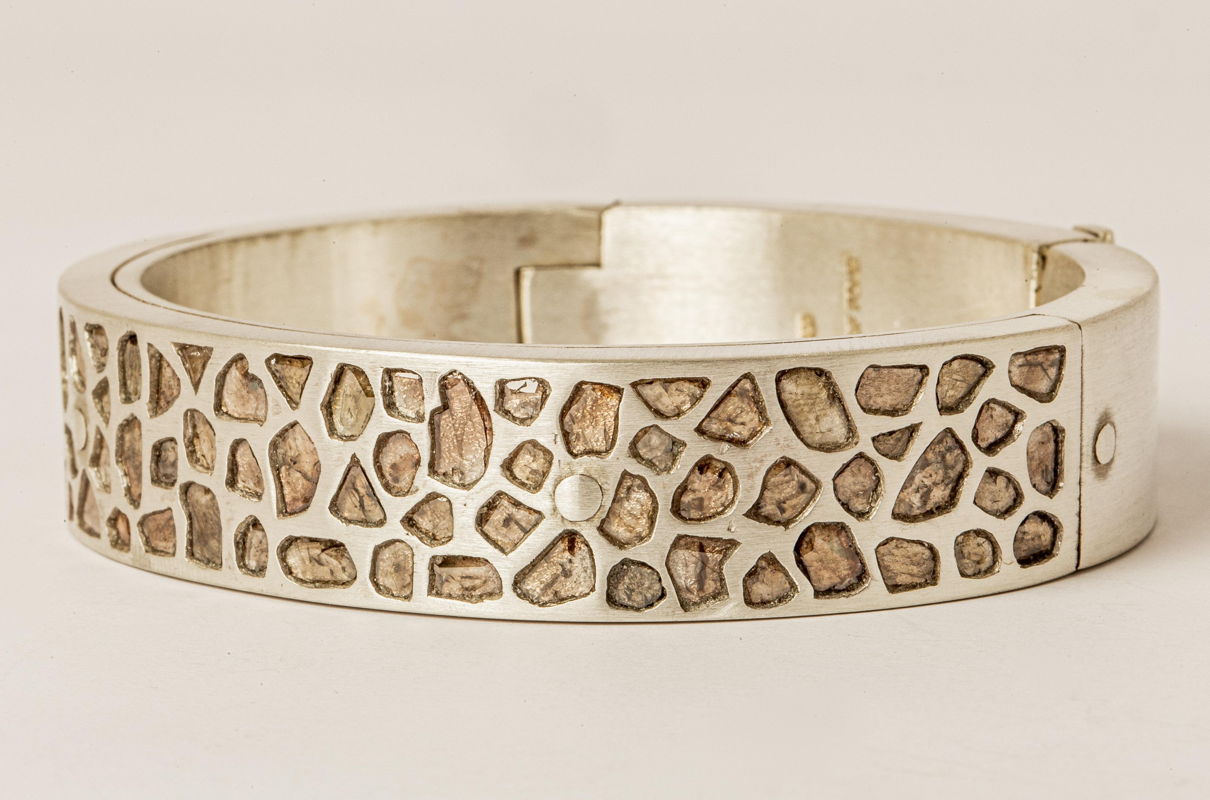 Sistema bracelet in sterling silver and slabs of rough diamond. These slabs are removed from a larger chunk of diamond. Each stone fragment and shape are absolutely unique and this is what makes it special. The 