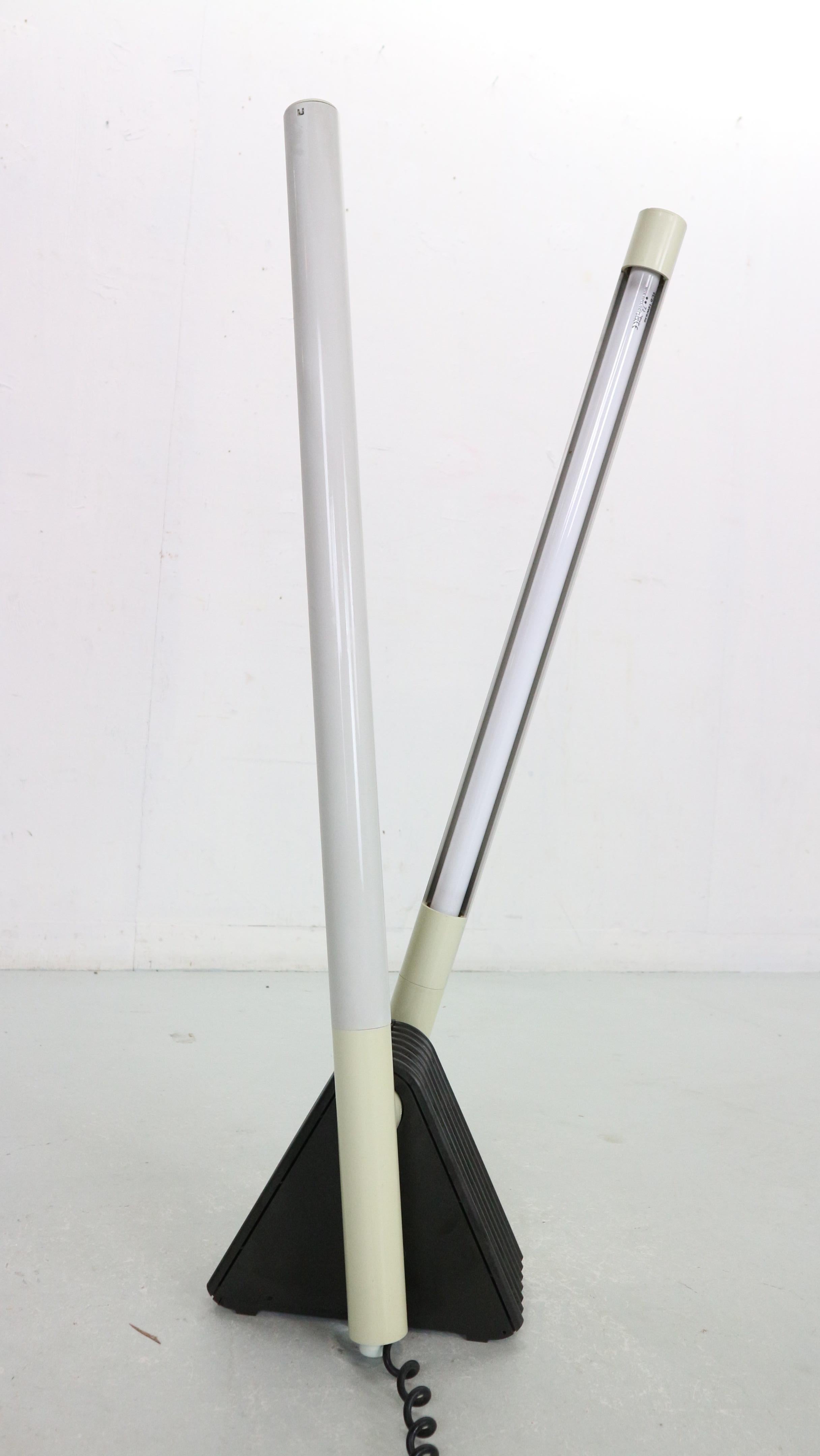 Very nice adjustable Sistema Flu lamp designed by Rodolfo Bonetto for Luci, Italy in 1981. This floor, wall or ceiling lamp has a black triangular base and two gray adjustable arms. The lamp can be placed on a wall, floor or ceiling. The arms can