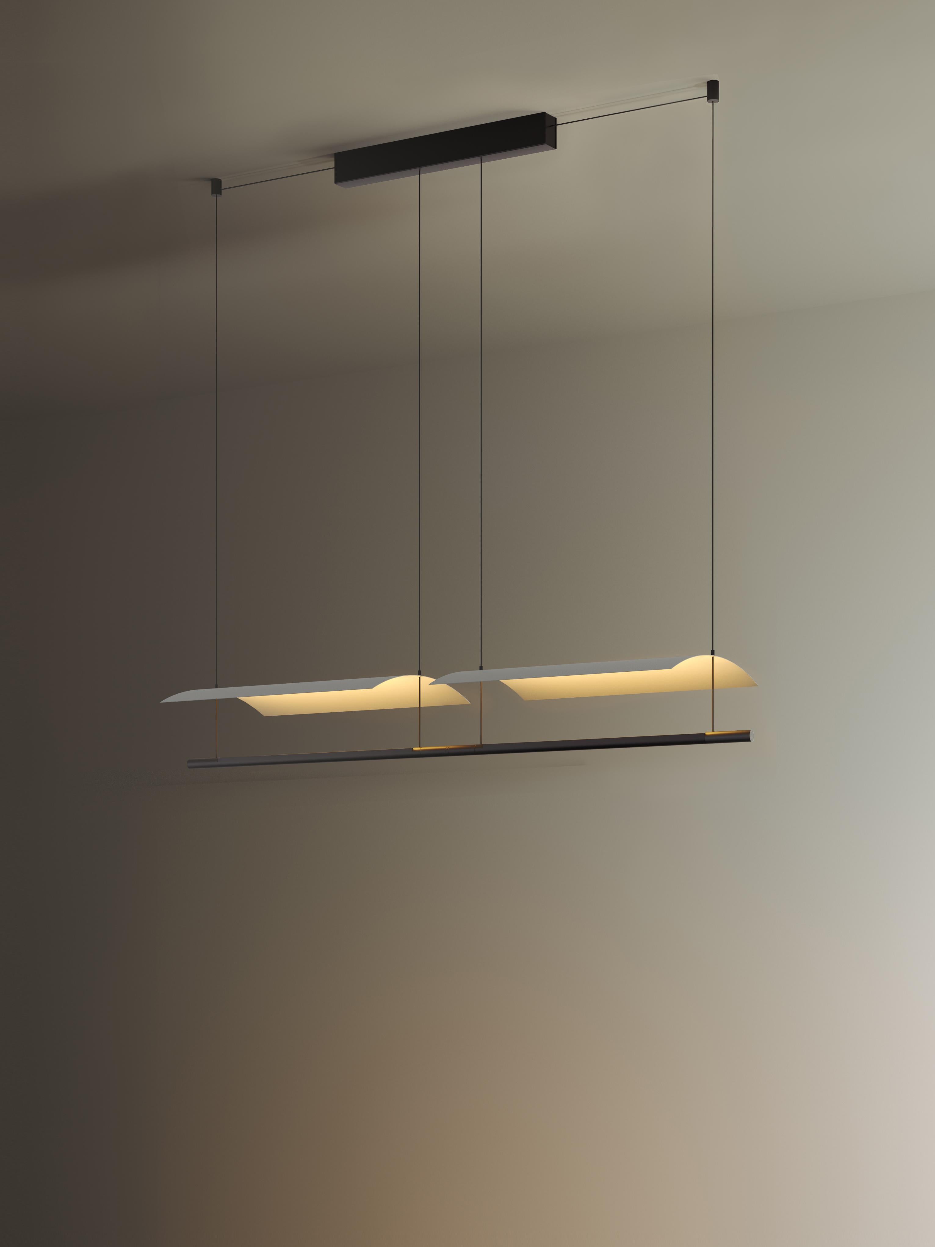 Lámina 45 pendant lamp by Antoni Arola
Dimensions: d 47.5 x w 30 x h 12.6 cm
Materials: Metal, plastic.
Available in other sizes.

A line of light and a thin metal sheet create a soft but effective levity. A marriage of the poetic and the