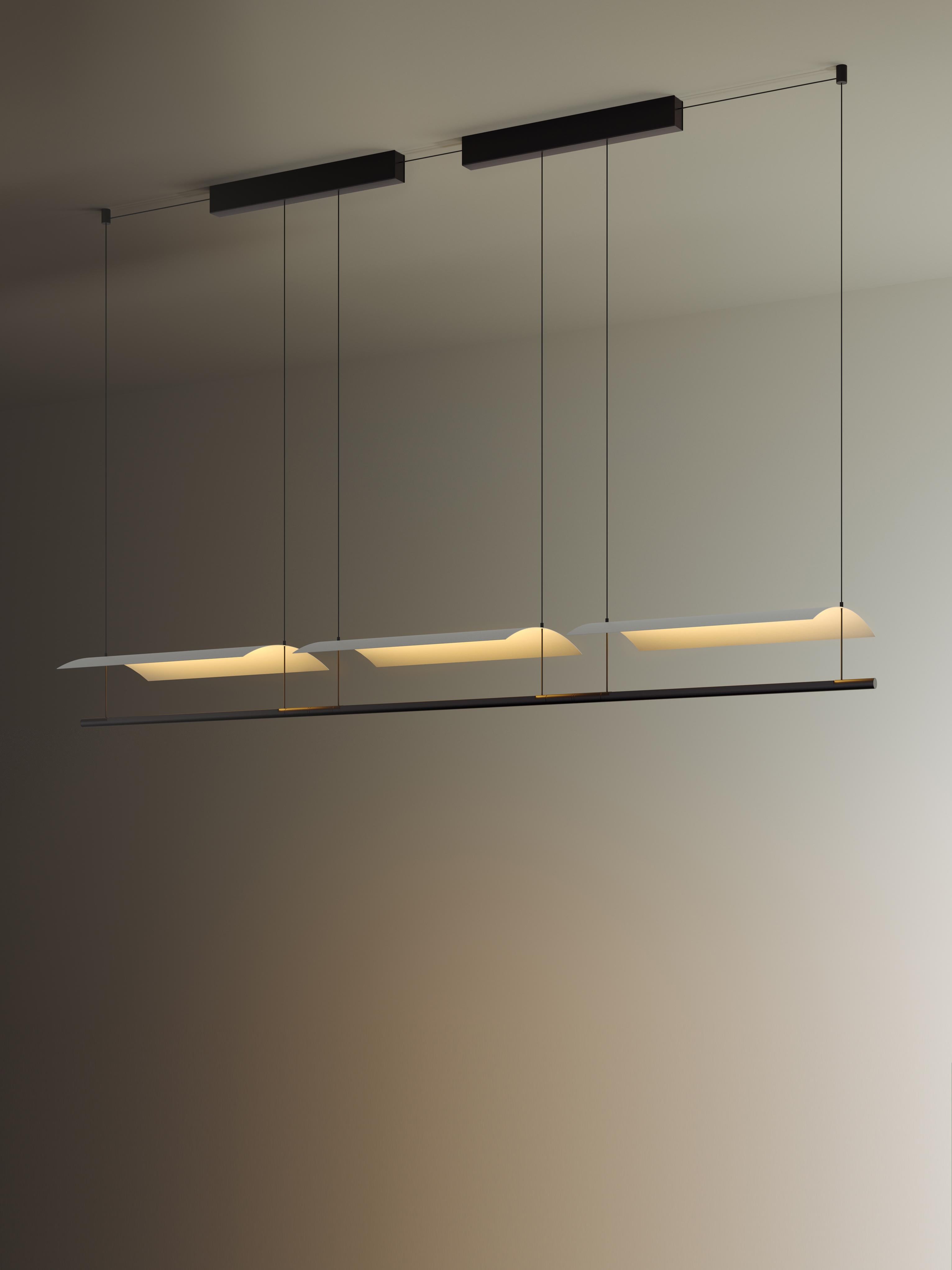 Sistema Lámina 45 pendant lamp II by Antoni Arola
Dimensions: D 177.1 x W 30 x H 12.6 cm
Materials: Metal, plastic.
Available in 2, 3 or 4 modules.

A line of light and a thin metal sheet create a soft but effective levity. A marriage of the