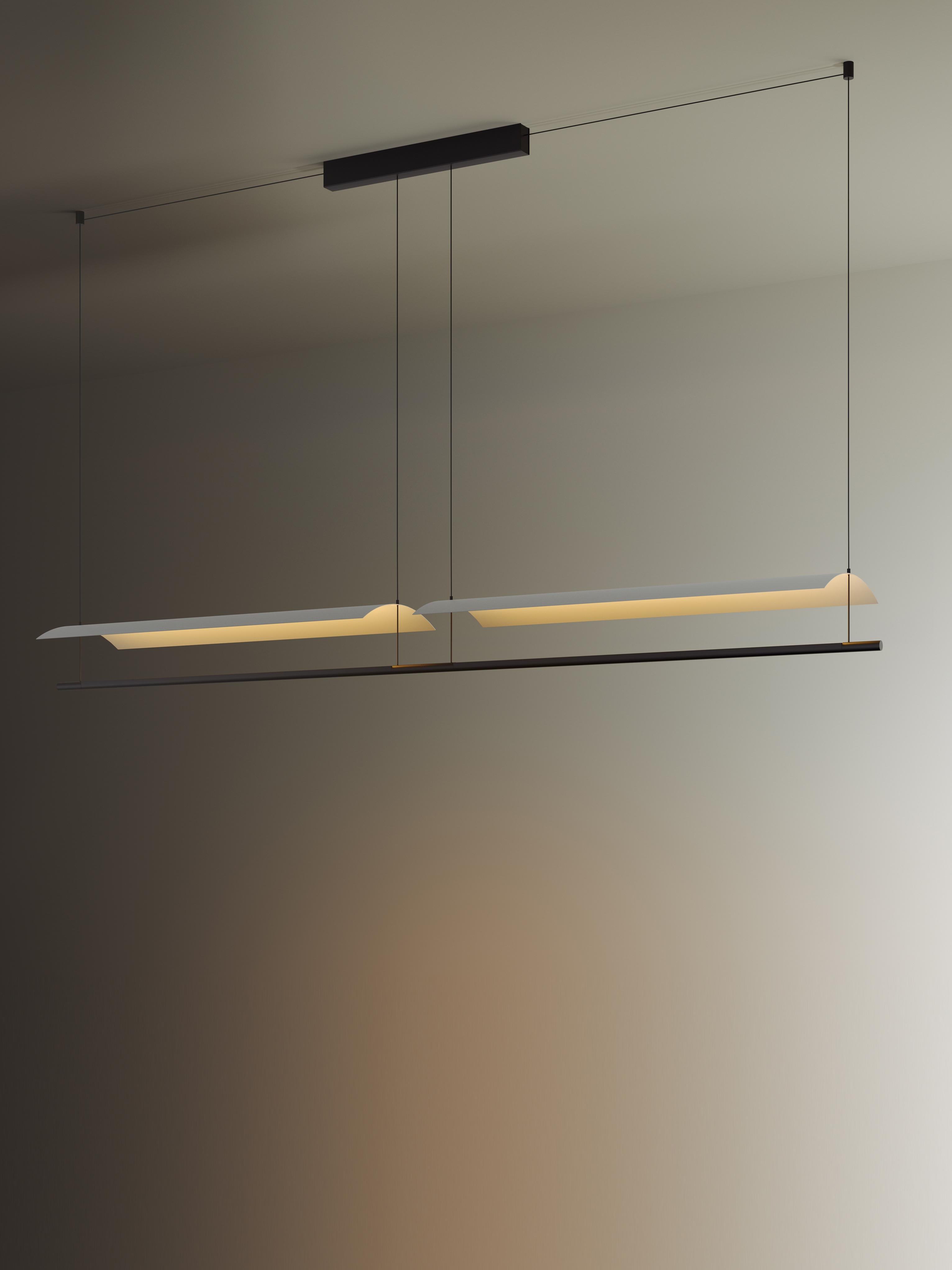 Sistema Lámina 85 pendant lamp by Antoni Arola
Dimensions: D 197.9 x W 30 x H 12.6 cm
Materials: Metal, plastic.
Available in 2,3 or 4 modules.

A line of light and a thin metal sheet create a soft but effective levity. A marriage of the poetic