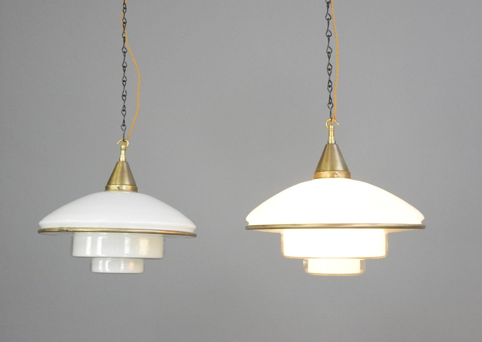 Sistrah P4 pendant lights By Otto Muller Circa 1930s

- Price is per light (8 available)
- Original brass gallery
- Comes with original ceiling rose
- Comes with 100cm of cable and chain
- Opaline glass top with stepped glass base
- Takes E27
