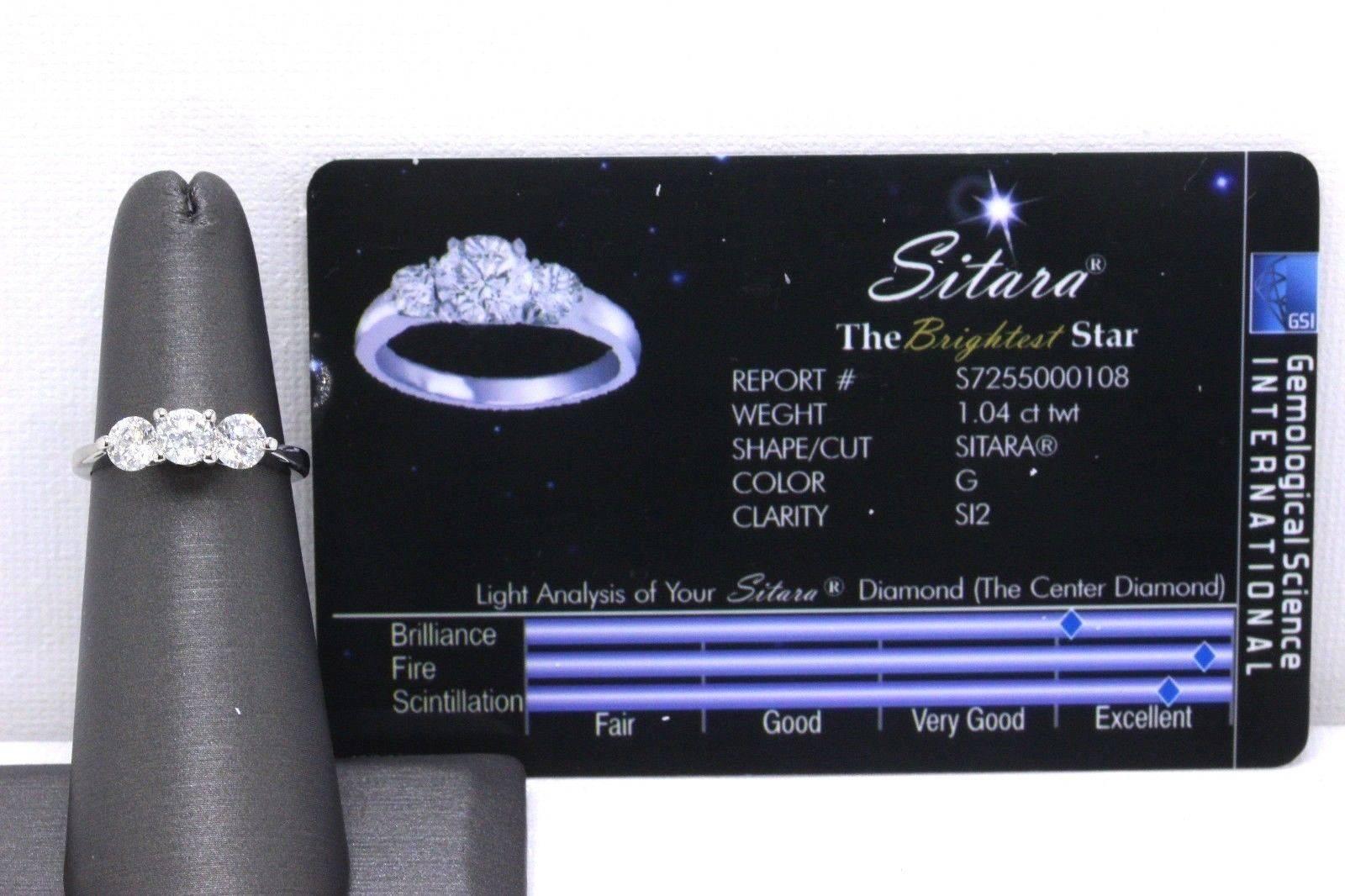 SITARA THE BRIGHTEST STAR DIAMOND ENGAGEMENT RING
Style: Three-Stone
Serial Number:  GSI Report # S7255000108
Metal:  14KT White Gold
Size:   5.25 - Sizable
Total Carat Weight:  1.04 TCW ( 0.32 cts - 0.40 cts - 0.32 cts )
Diamond Shape:  Sitara