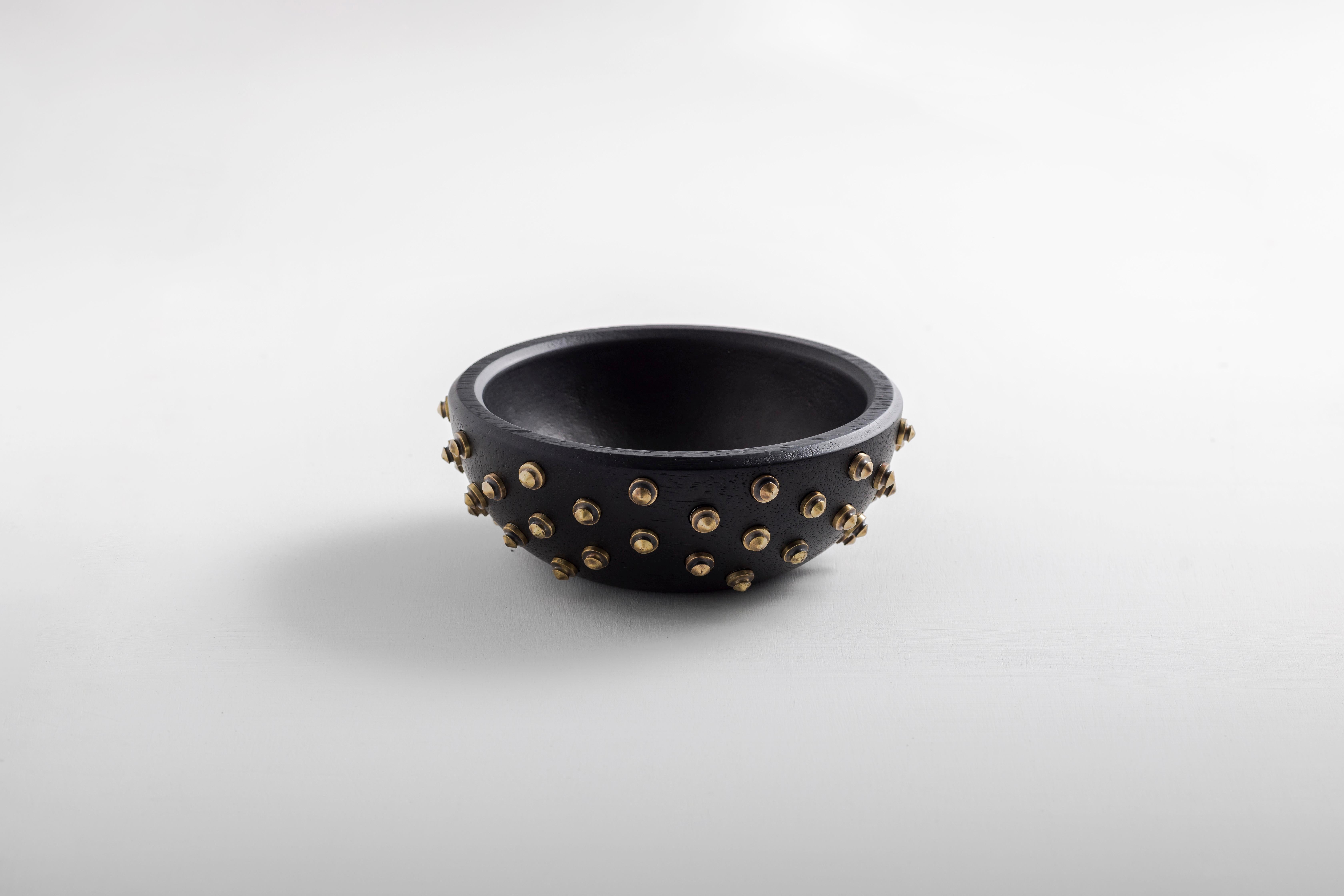 Decorative lathed solid seike wood bowl, with bronze or stainless steel details.

Drawing inspiration from the sacral and baroque motifs of Quito, as well as Ecuador’s highest and dormant volcano, these bowls are meticulously hand-carved from