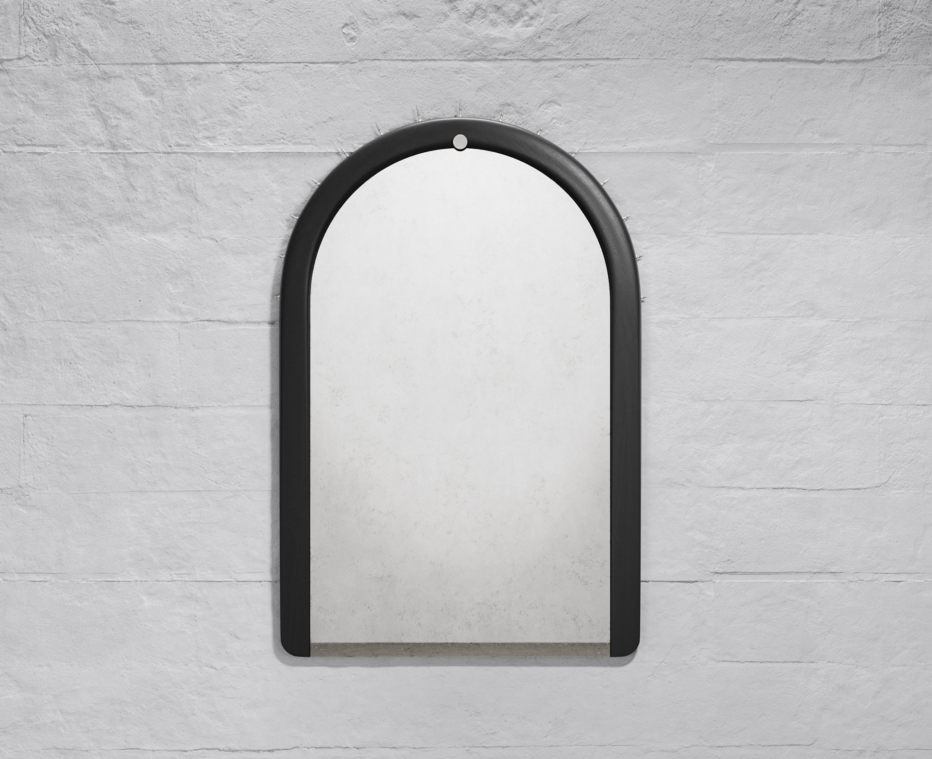 Wall mirror made of solid seike wood body with a natural oil finish, antique mirror glass, and lathed bronze or stainless steel hardware. Customizations available upon request.

The SITIERA_03 wall mirror is an abstraction of the Virgen de Quito