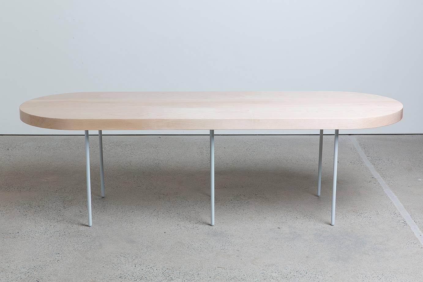 A solid, pill shape, Maple coffee table with gray powder coated spindle steel legs. Handmade to order, this simple and minimal table will resonate well with any environment or situation.

Built in Portland, OR, this table is available in custom
