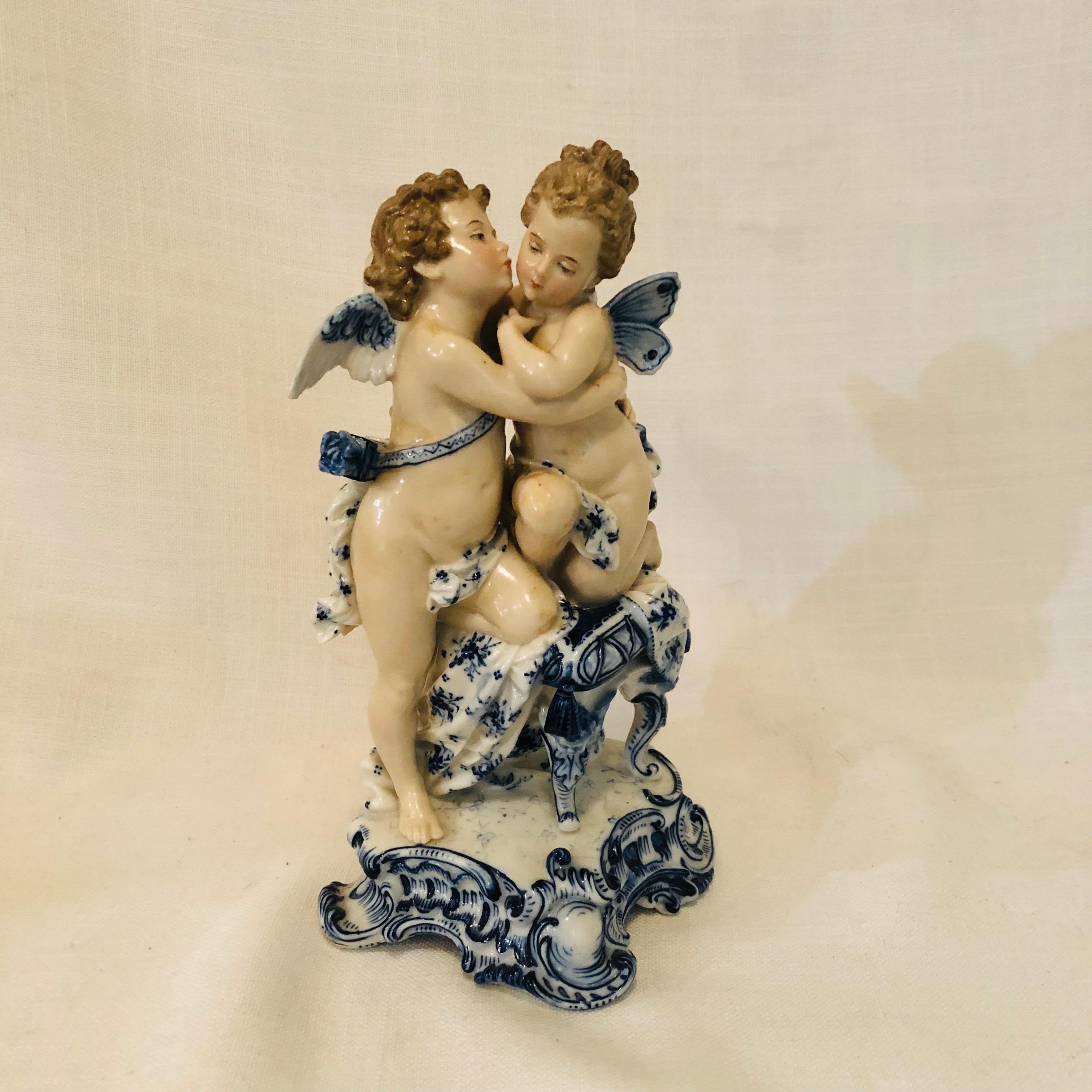 Look at this absolutely charming figurine of a boy and a girl angel or putti with wings sitting on a bench kissing. The modeling of these figures of putti is very well done, as you can see in the pictures. Look at their beautiful facial expression