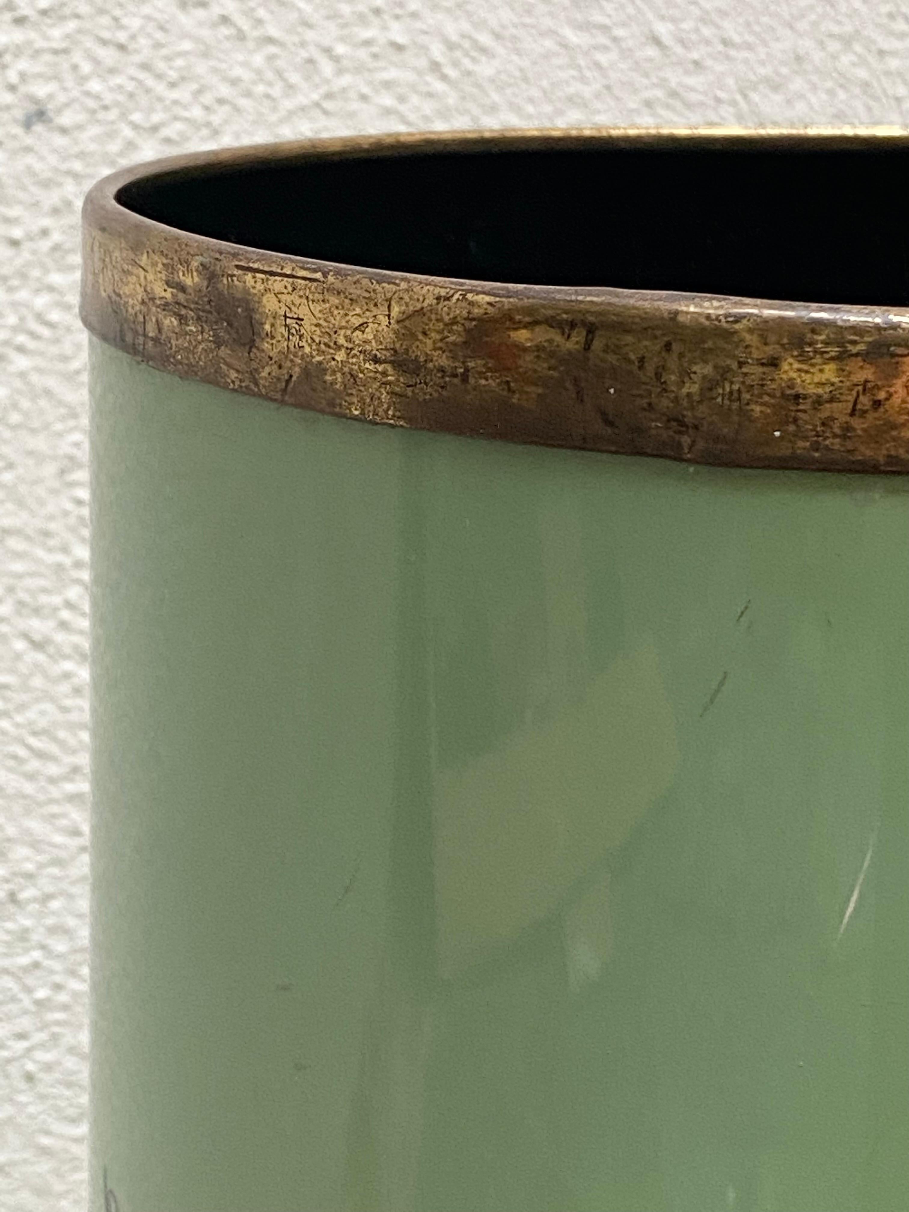 1950s Mid-Century Modern enameled metal umbrella stand designed by Siva Poggibonsi, Italy. Tall oval shape with gilded brass trim on top and on the bottom. Green color background with designs all around.