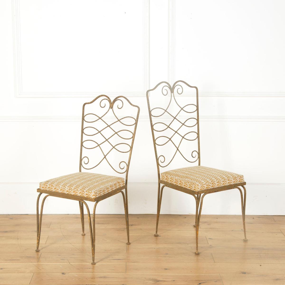 A beautifully crafted set of 6 wrought iron dining chairs attributed to Rene Prou. Seats recovered in Walter G fabric. Two chairs slightly larger (107 x 46 x 53).