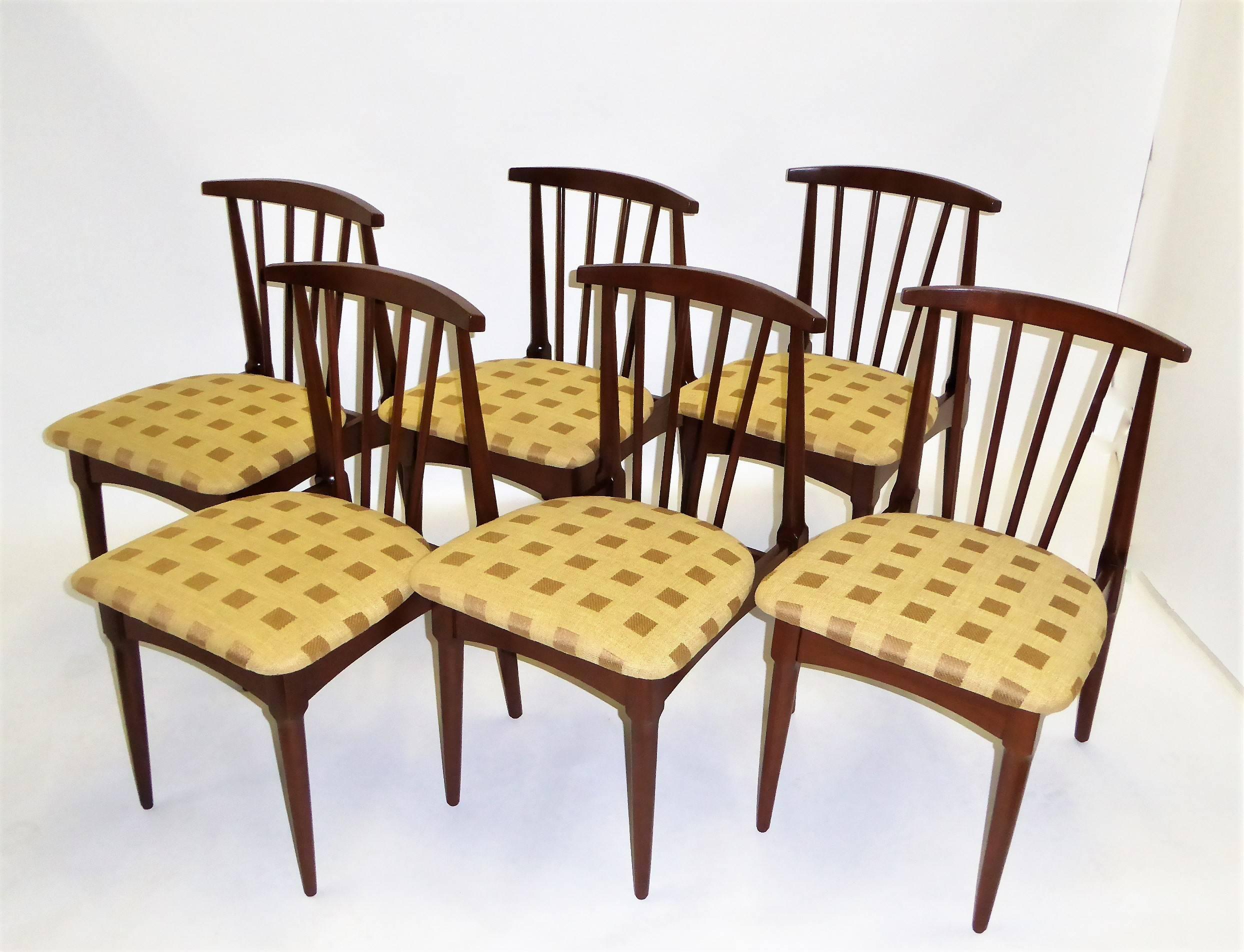 Six 1950s Mid-Century Modern walnut spindle back dining chairs. Danish modern styling and similar to Tomlinson Sophisticates Line, these beauties have been restored and have plush re-upholstered seats in a neutral woven fabric. All strong and