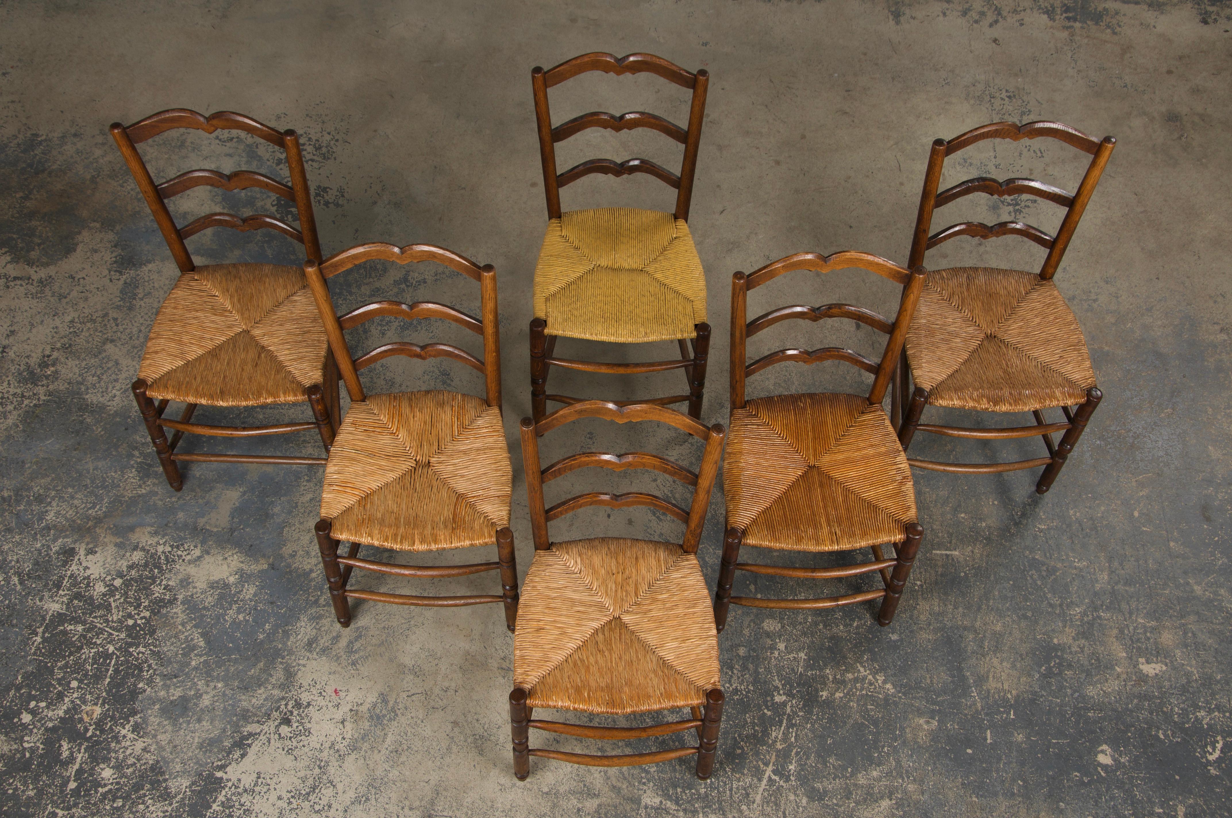 Hand-Carved Six 19th Century French Provincial Ladder Back Oak Dining Chairs W/ Rush Seats For Sale