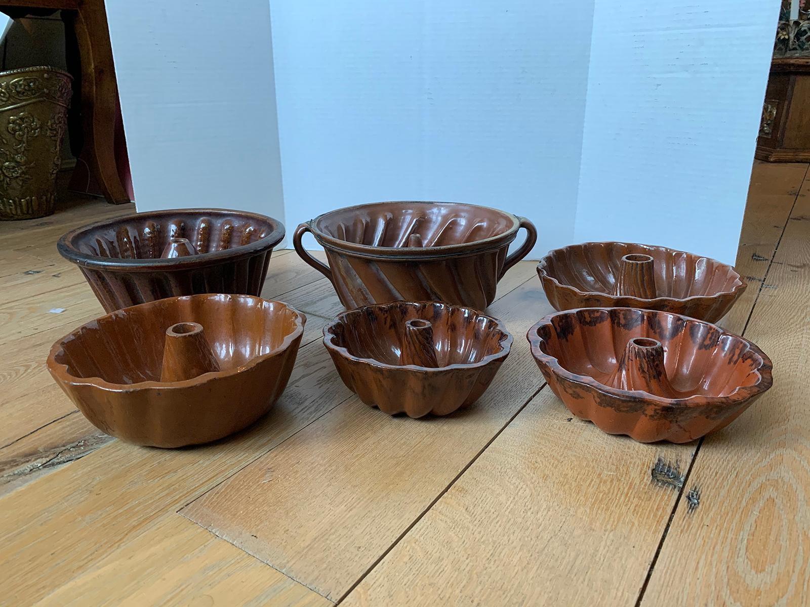 Assembled set of six 19th century Pennsylvania Redware glazed pottery Turks head Bundt molds, unmarked.
From smallest to largest: 7.5