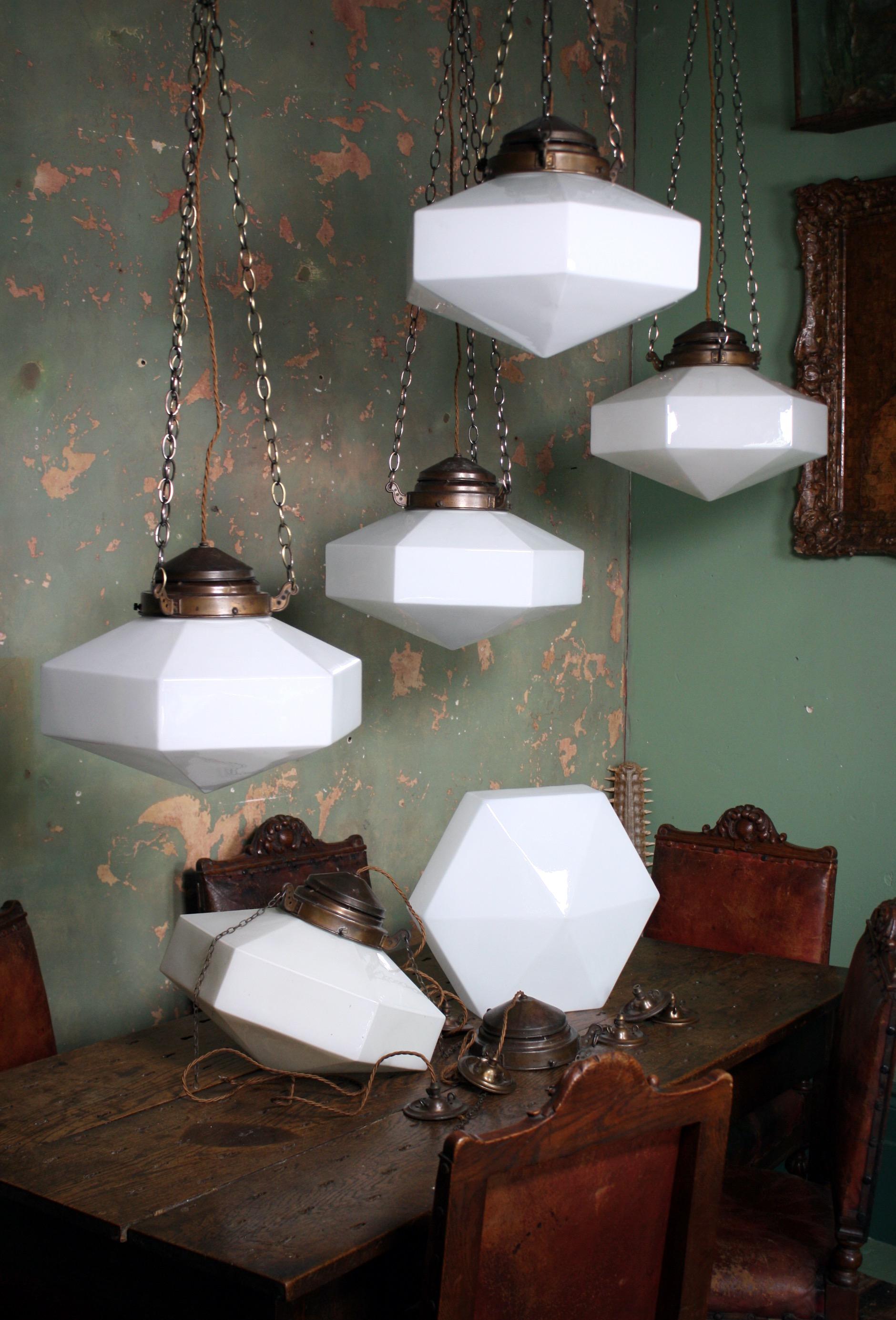 A rare run of six (3 remaining) large Hexagonal Hailwood & Ackroyd Opaline pendants with a conical underbelly

The bronze galleries have a decorative three arm hanging system with an enclosed cap, the galleries and glass are stamped with the makers