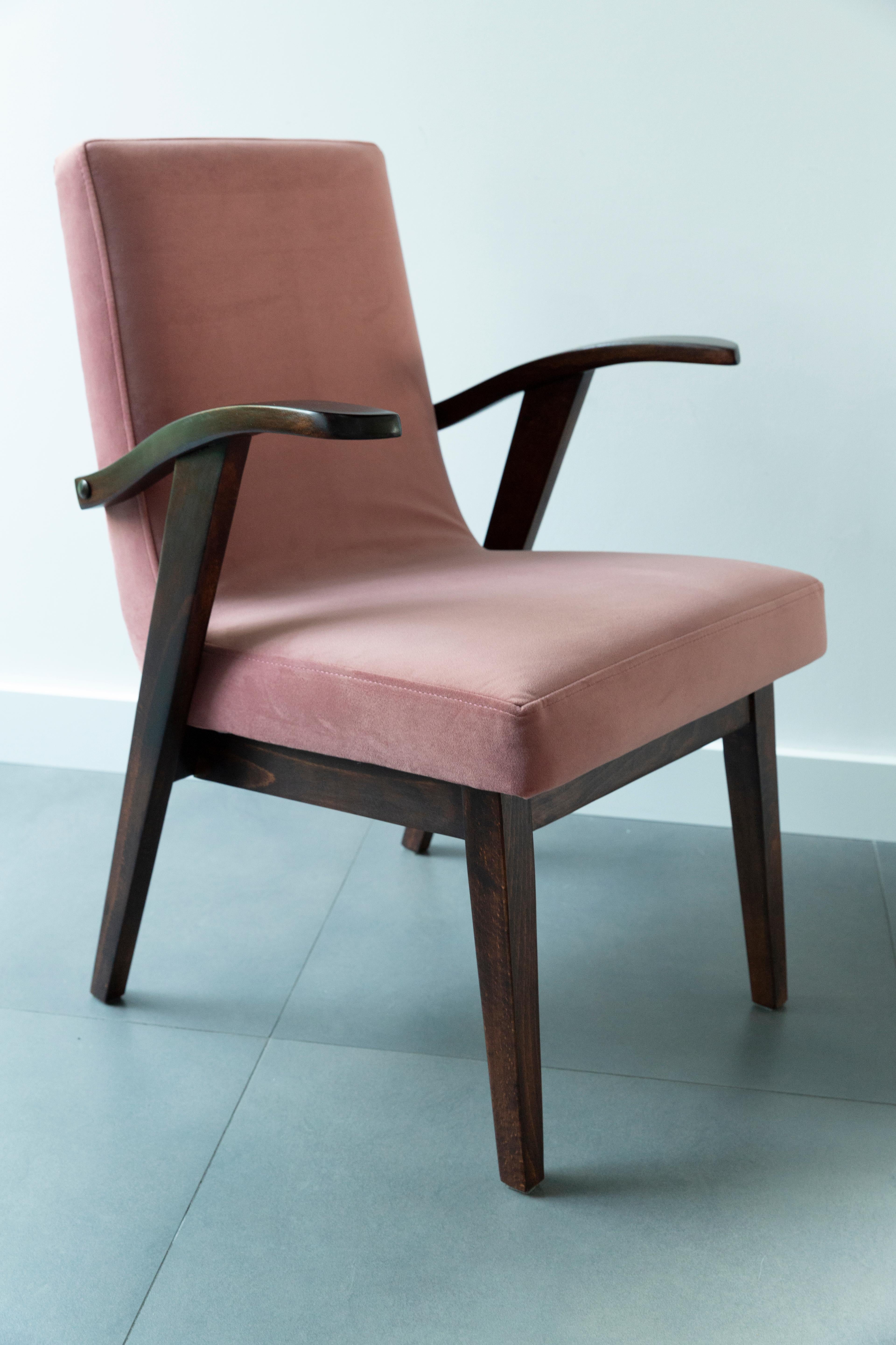 Armchair designed by Mieczyslaw Puchala. Dark brown wood combined with a dusty pink beautiful velvet gives it elegance and nobility. The chair has undergone a full carpentry and upholstery renovation. The wood is in excellent condition after full
