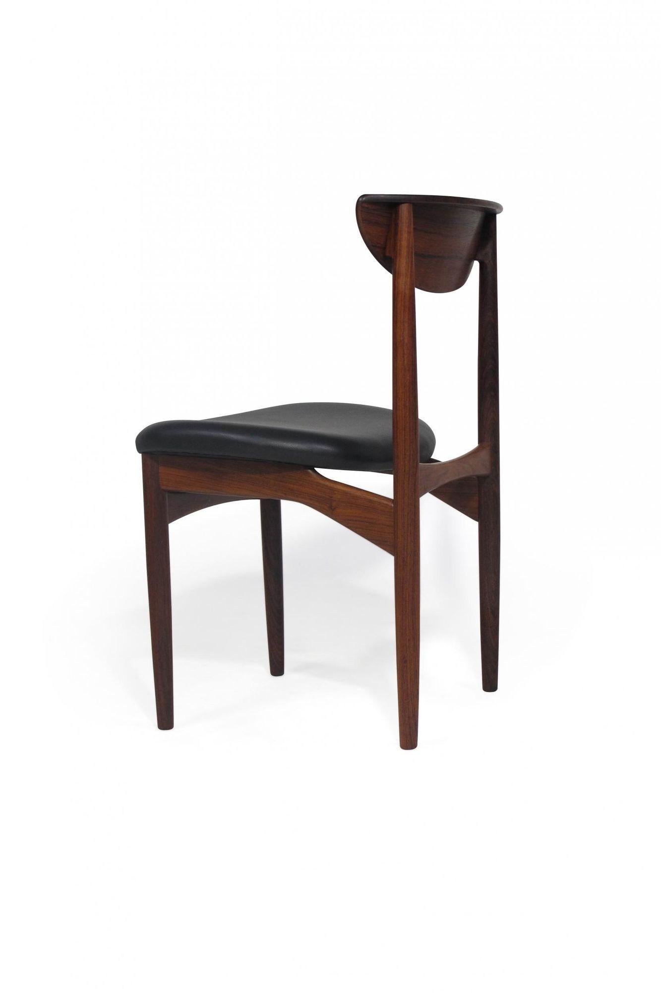 Danish dining chairs designed by Kurt Ostervig for K.P Møbelfabrik, 1959, Denmark. The chairs are handcrafted of solid Brazilian rosewood frames with sculpted backrests.Newly upholstered in black leather. The wood used is of the finest rosewood,