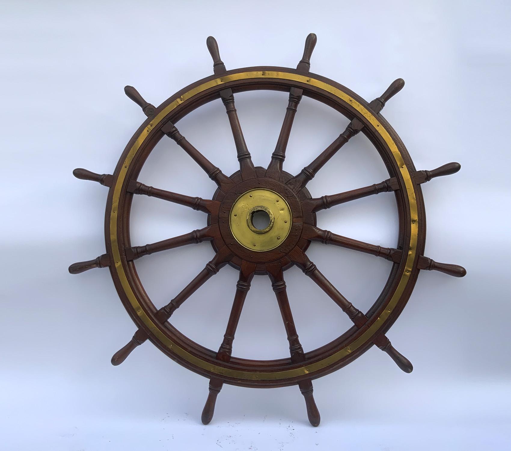 Twelve spoke varnished wood ships wheel with inlaid ring and brass hub. Carved spindles with extra details. Very impressive. 

Weight: 138 LBS
Overall Dimensions: 79