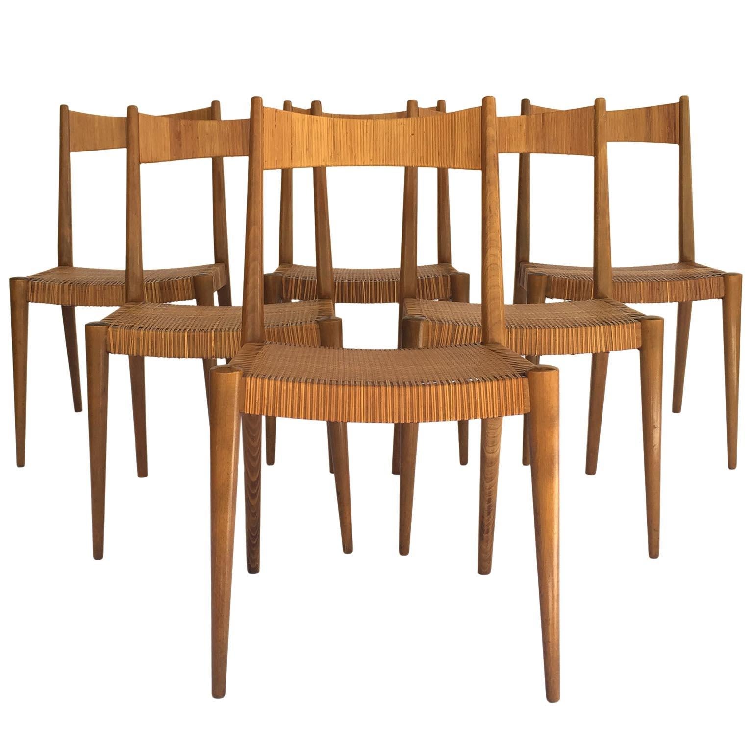 A set of six dining room or side chairs designed by Anna-Luelja Praun (1906-2004), Vienna, Austria, manufactured in midcentury, circa 1950.
The seats and backs are covered with cane or wicker. A few of the cane has been restored and replaced with